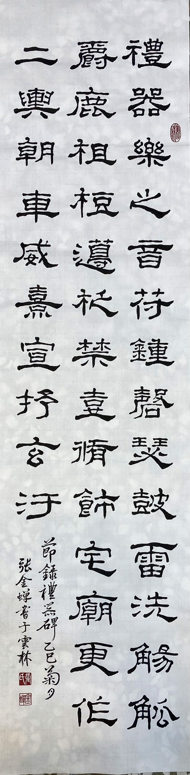 A person stands in a dimly lit art gallery