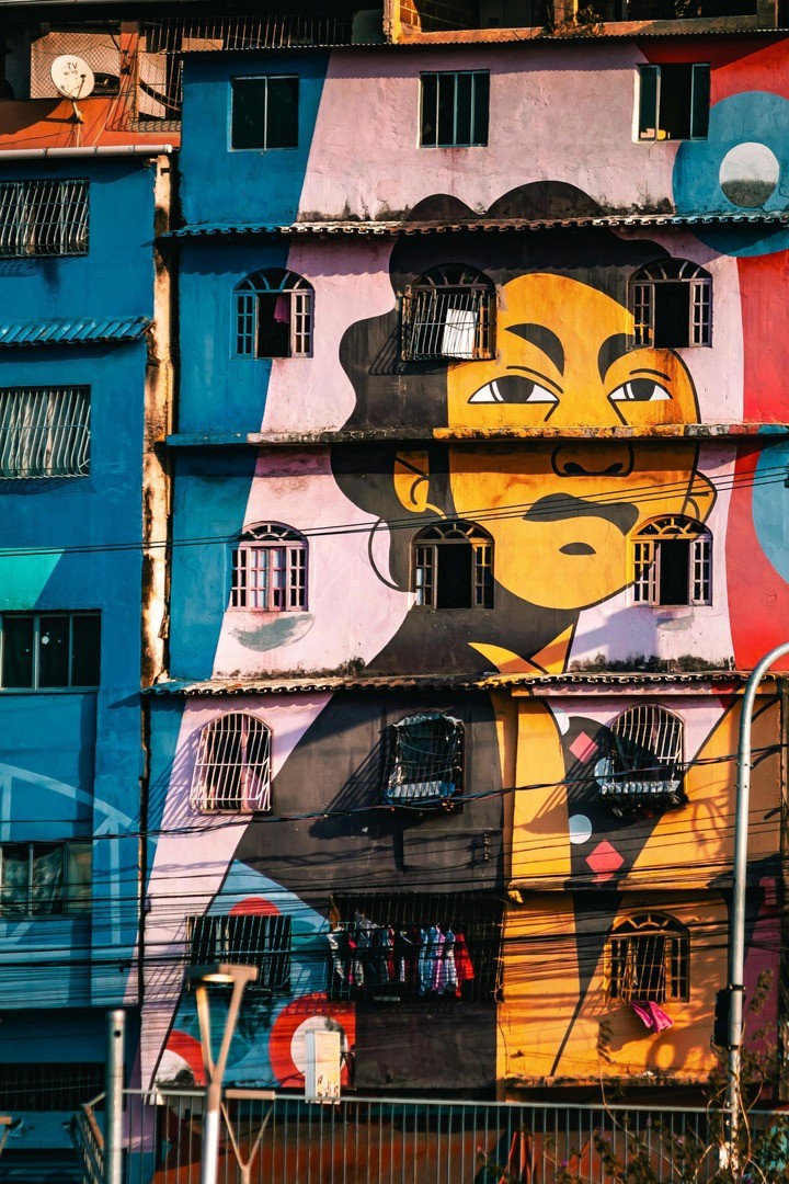 Architectural street photography featuring a multi-story building covered in vibrant street art.