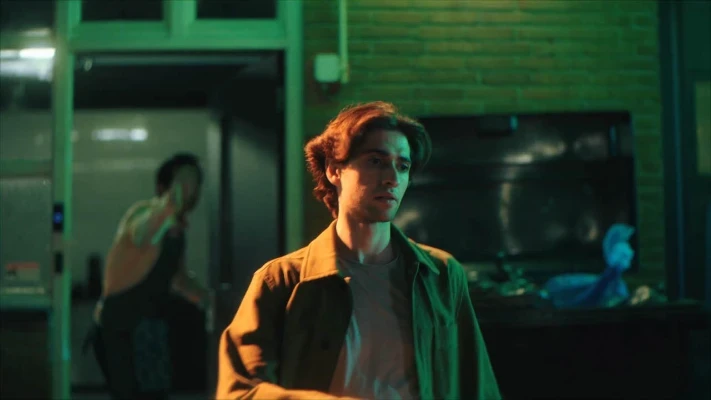 A guy walking towards his bike