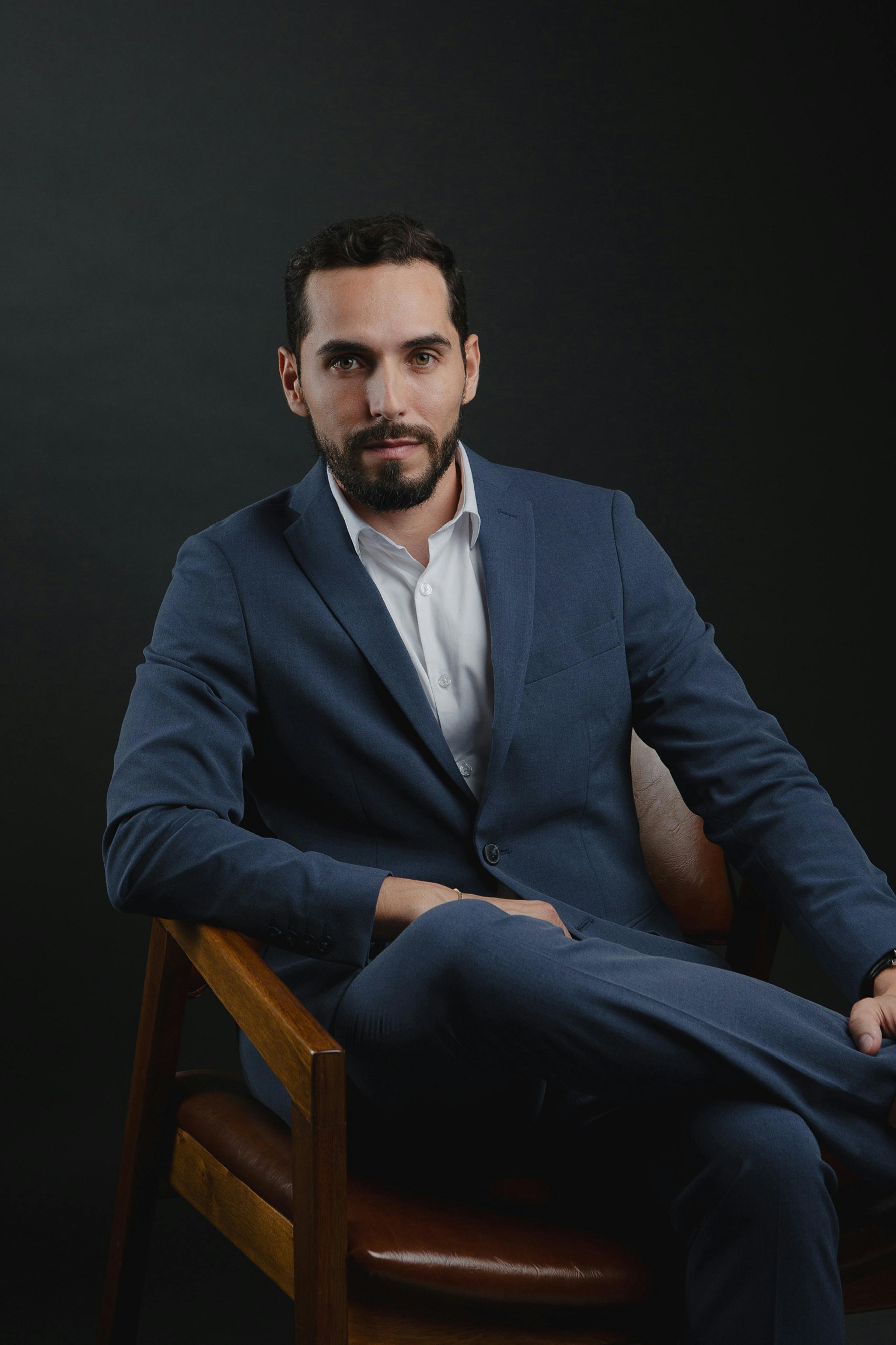 Portrait of a laughing person with curly hair wearing a white shirt