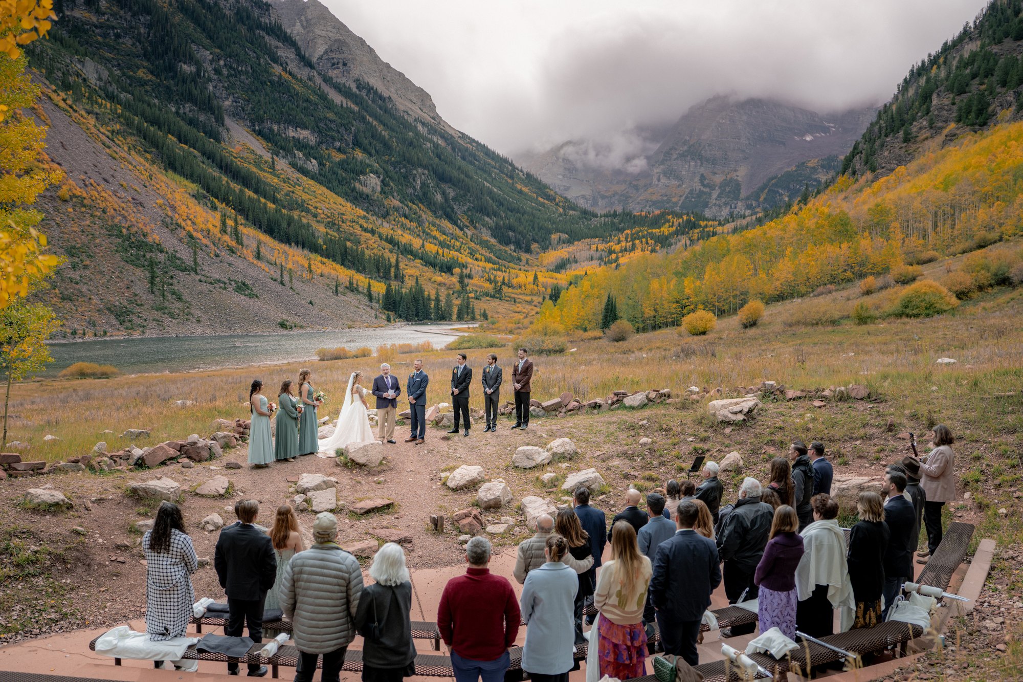 Guests seated for a wedding ceremony at the Maroon Bells Amphitheater overlooking Maroon Lake