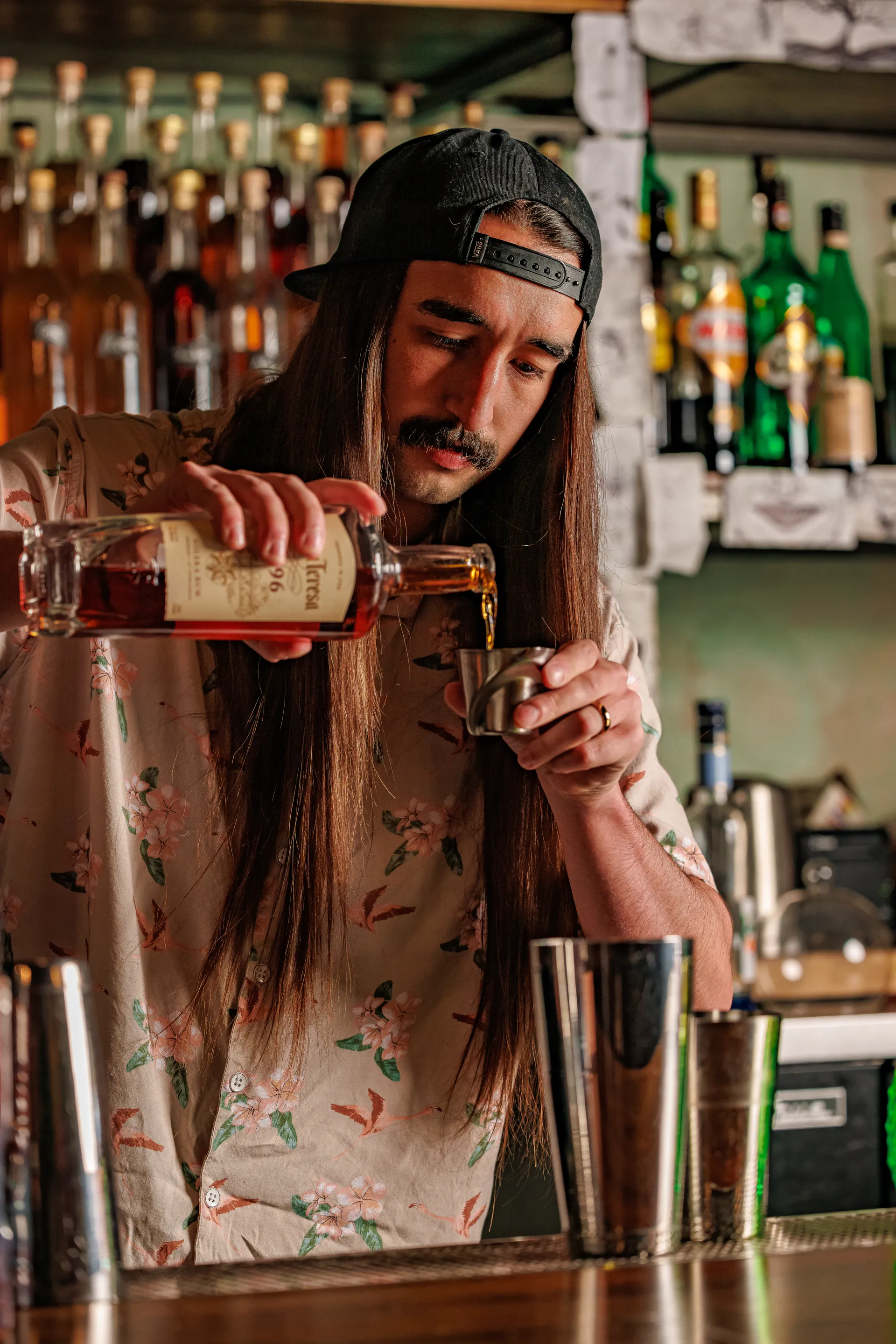 Bartender pouring rum into a jigger