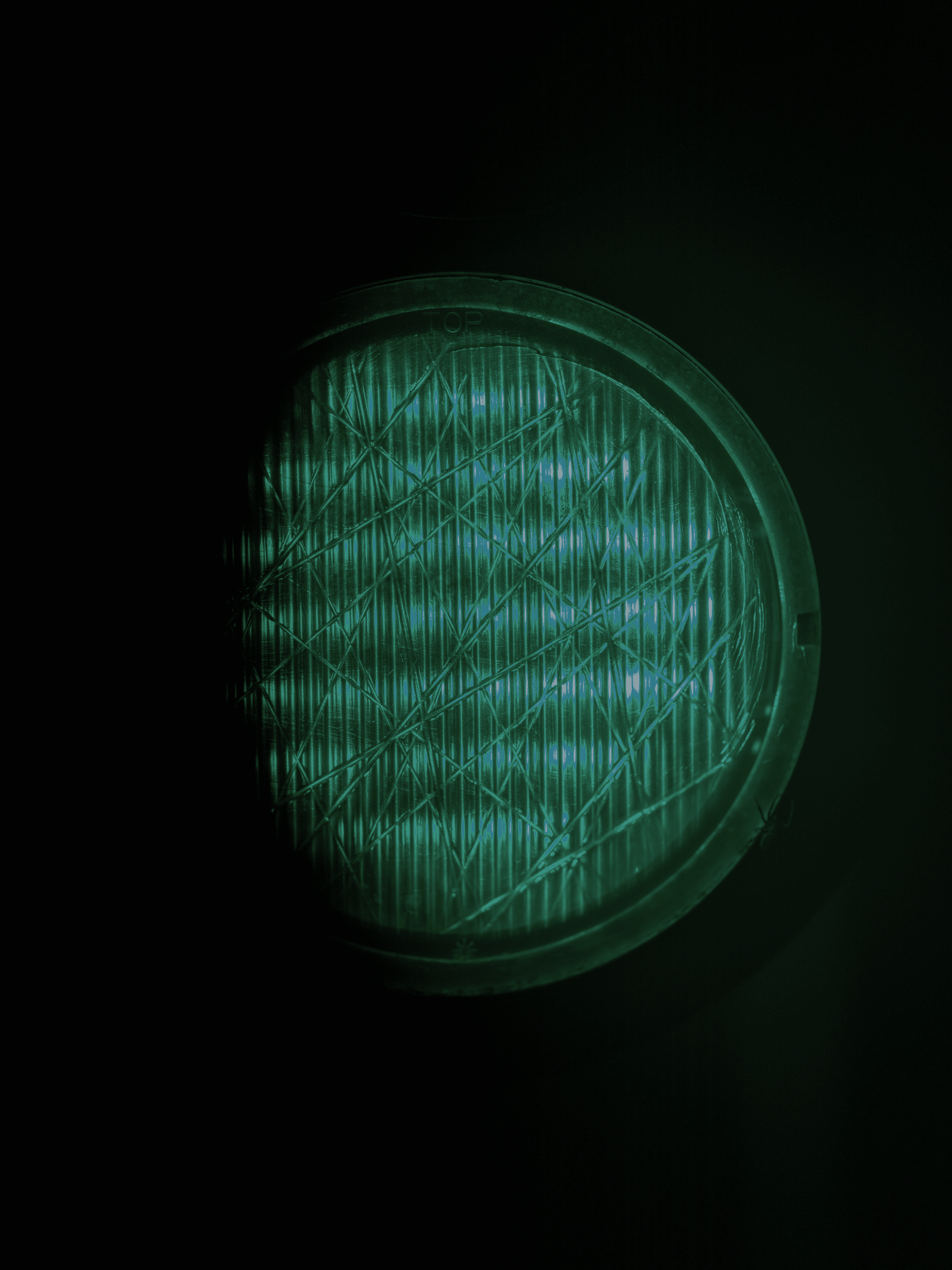 A close up of a green light in the dark
