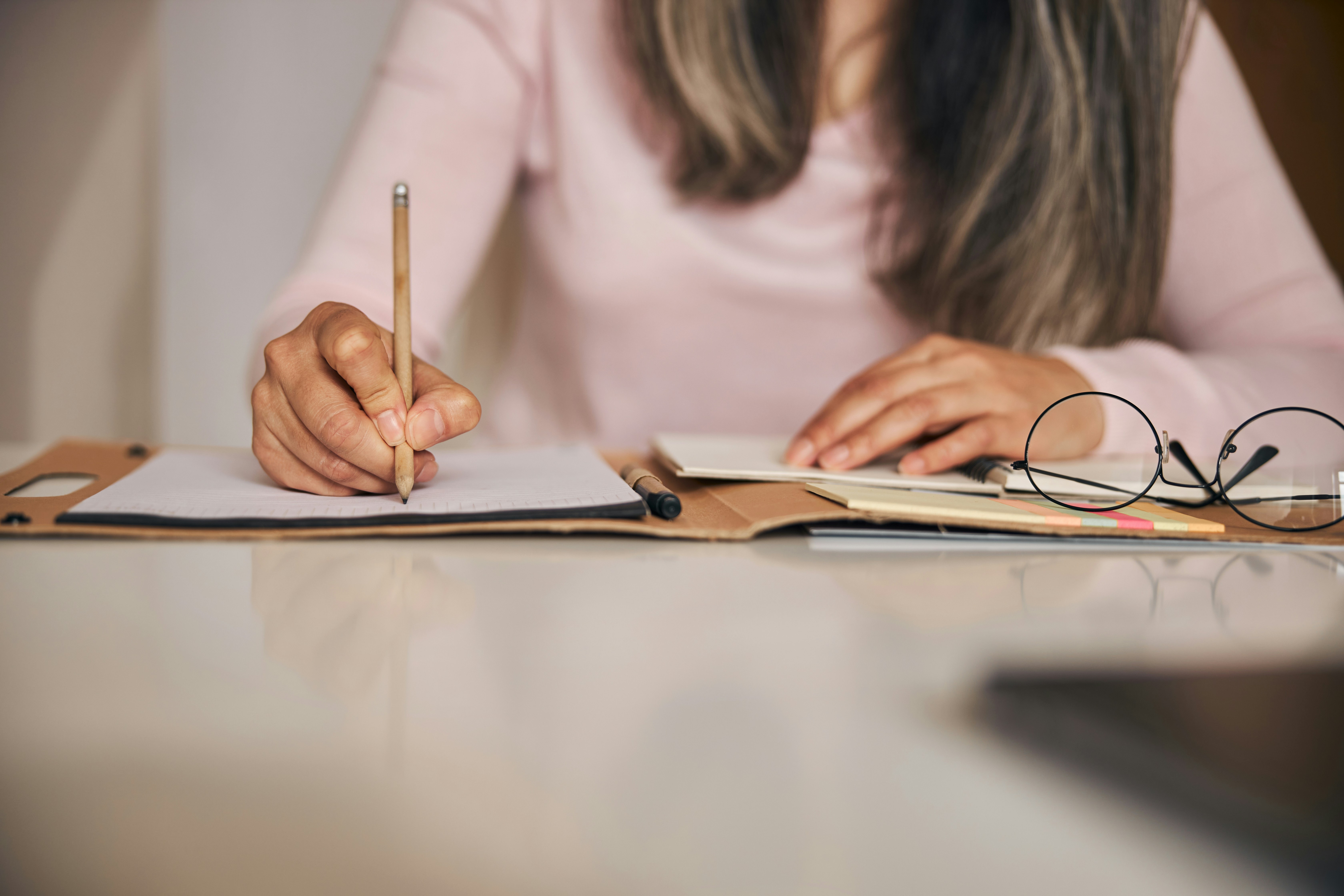 Female writing on a notepad