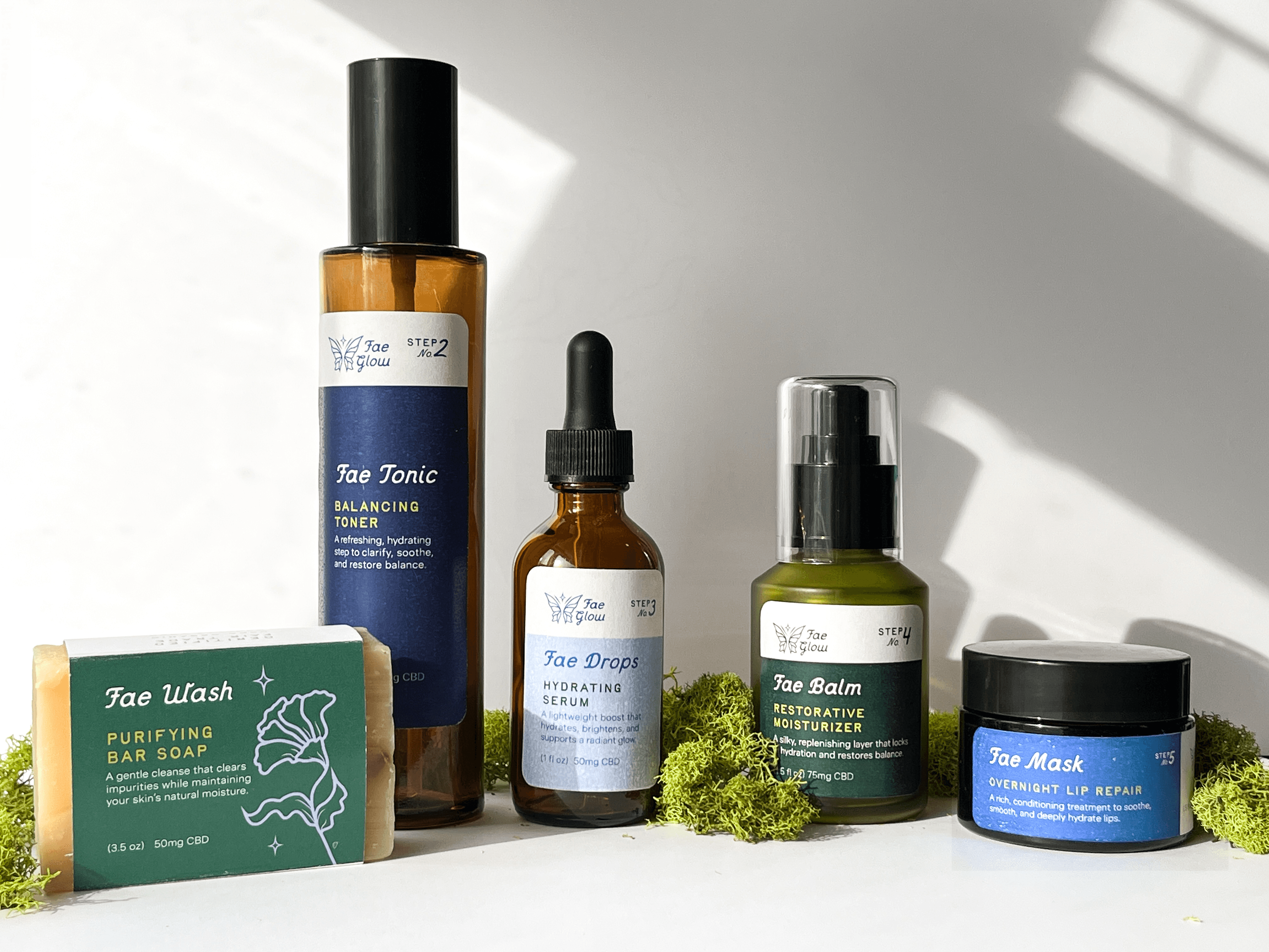 A variety of skincare products displayed, including bottles, a bar of soap, and a jar on a light background.