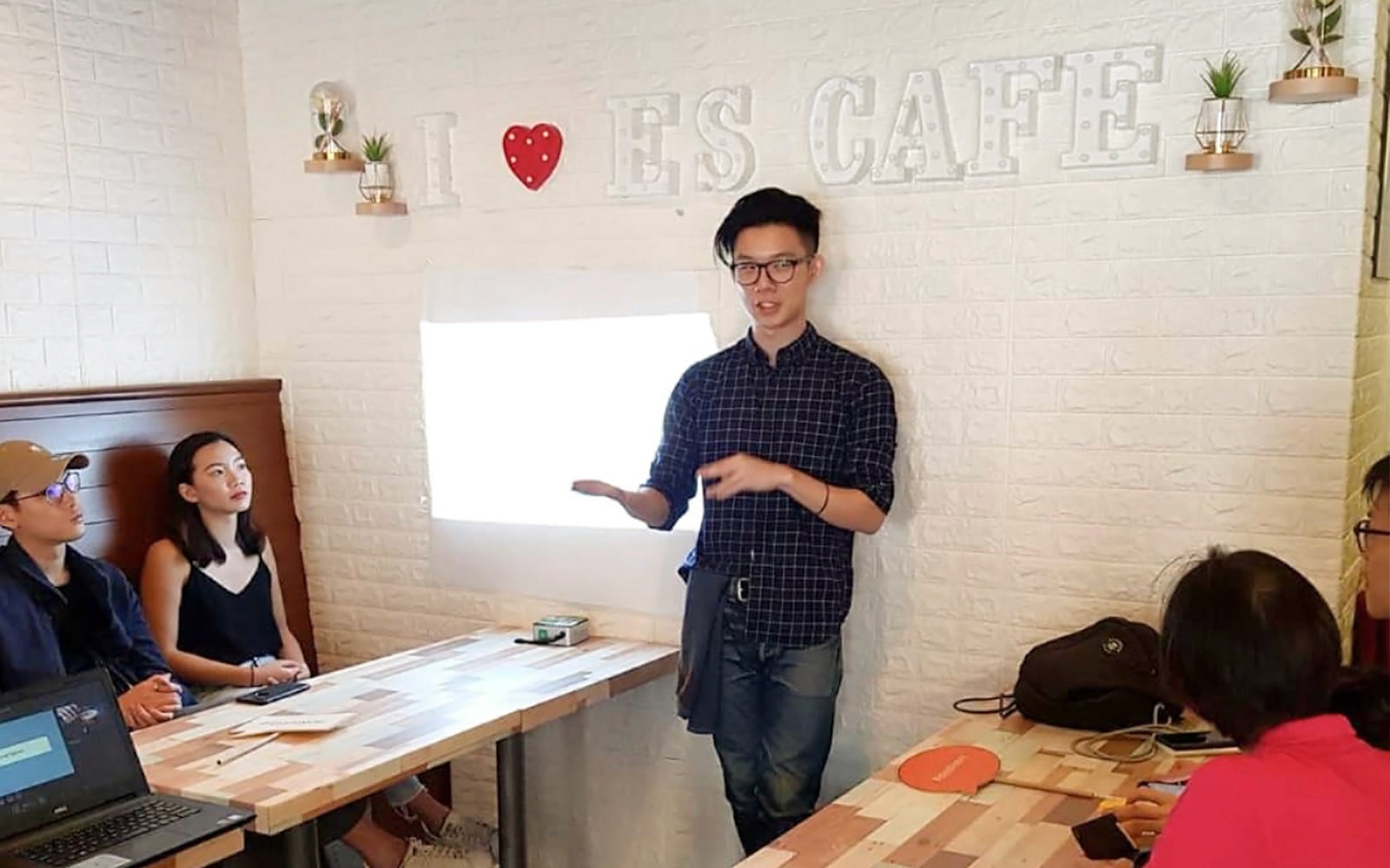 Coffee workshop presentation at Nineteen95 Espresso Bar with attendees listening attentively.