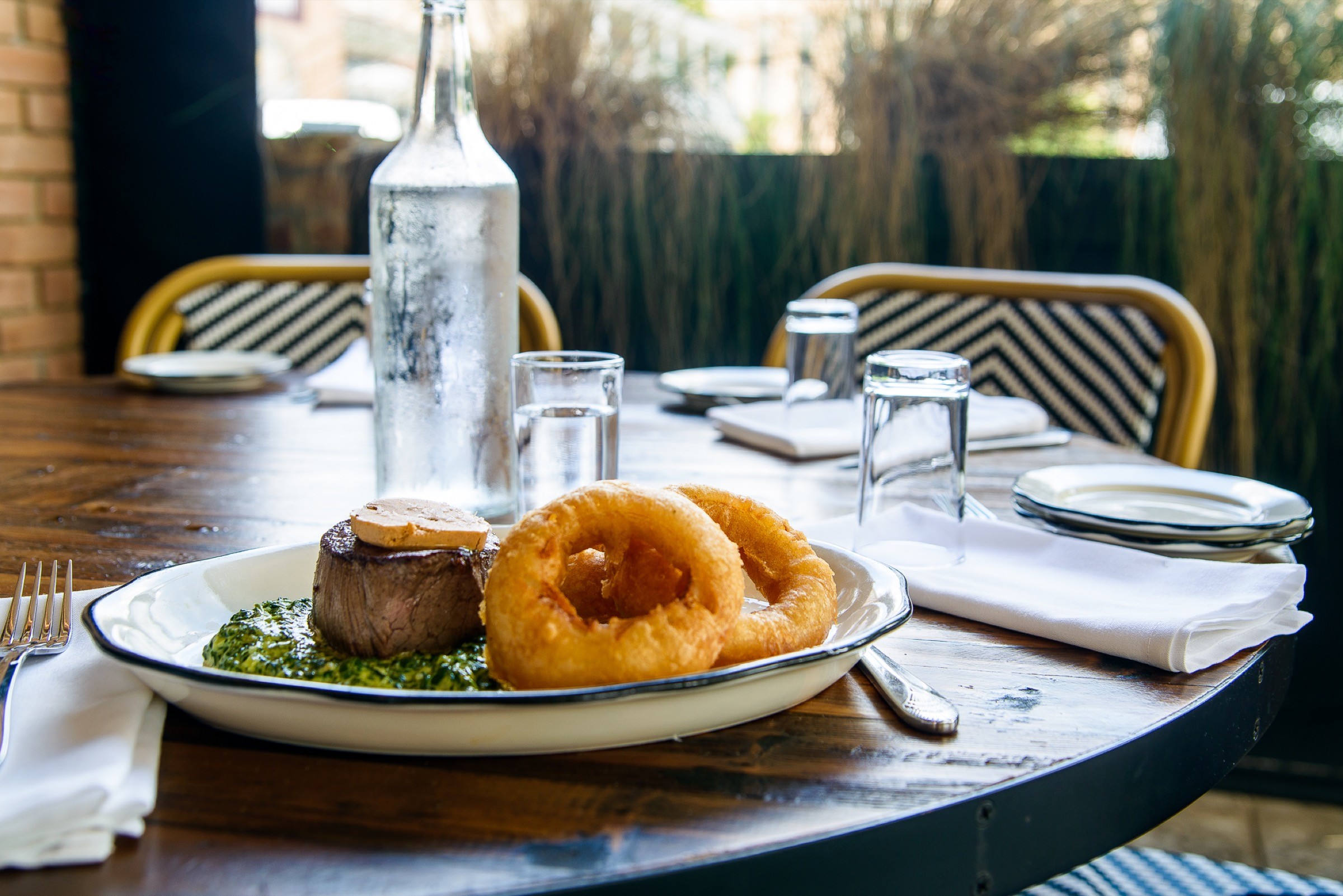 Plated restaurant dish in an editorial dining environment