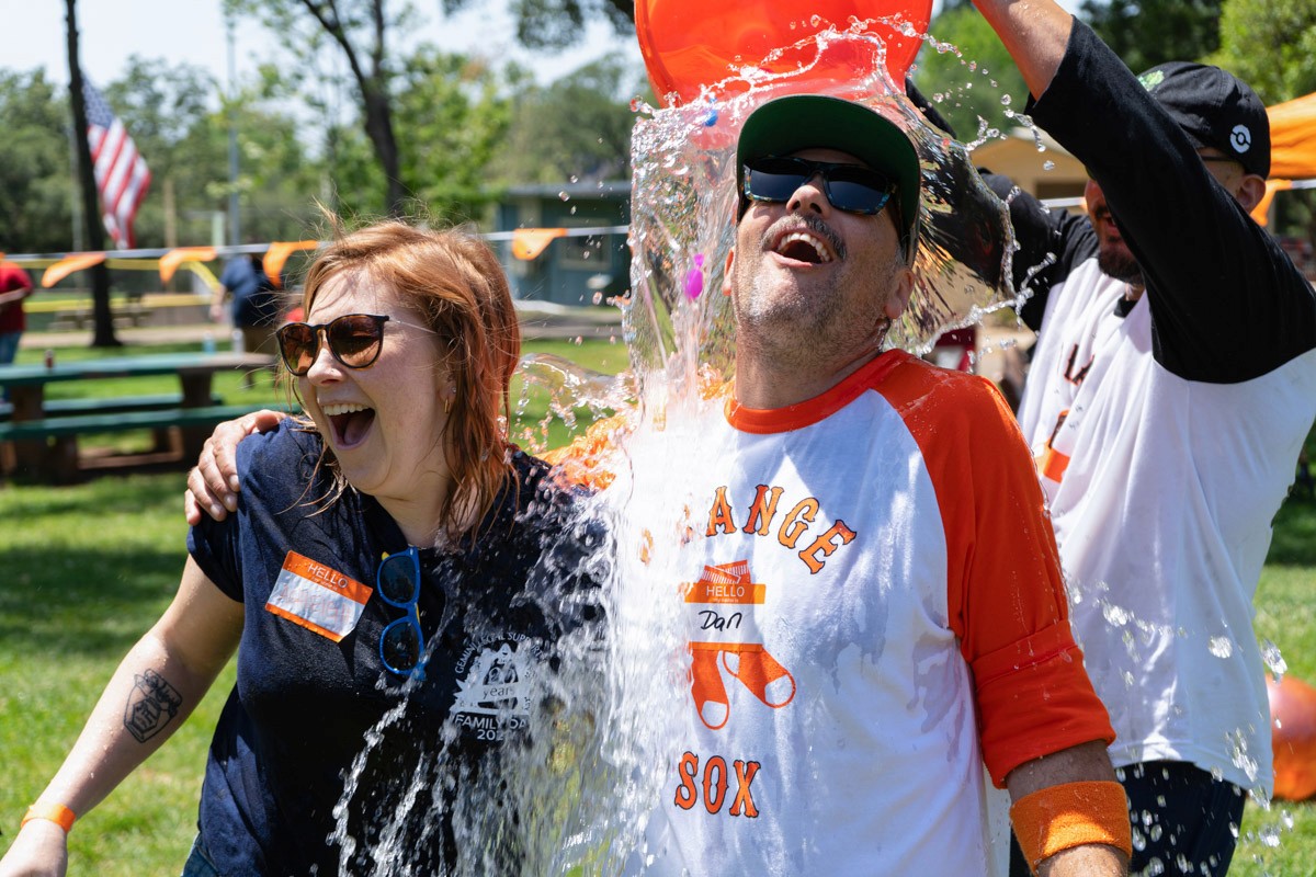 Founder Dan Mora and VP of Operations Ashleigh Rivera getting splashed at Northern California Family Day for Gemini Legal