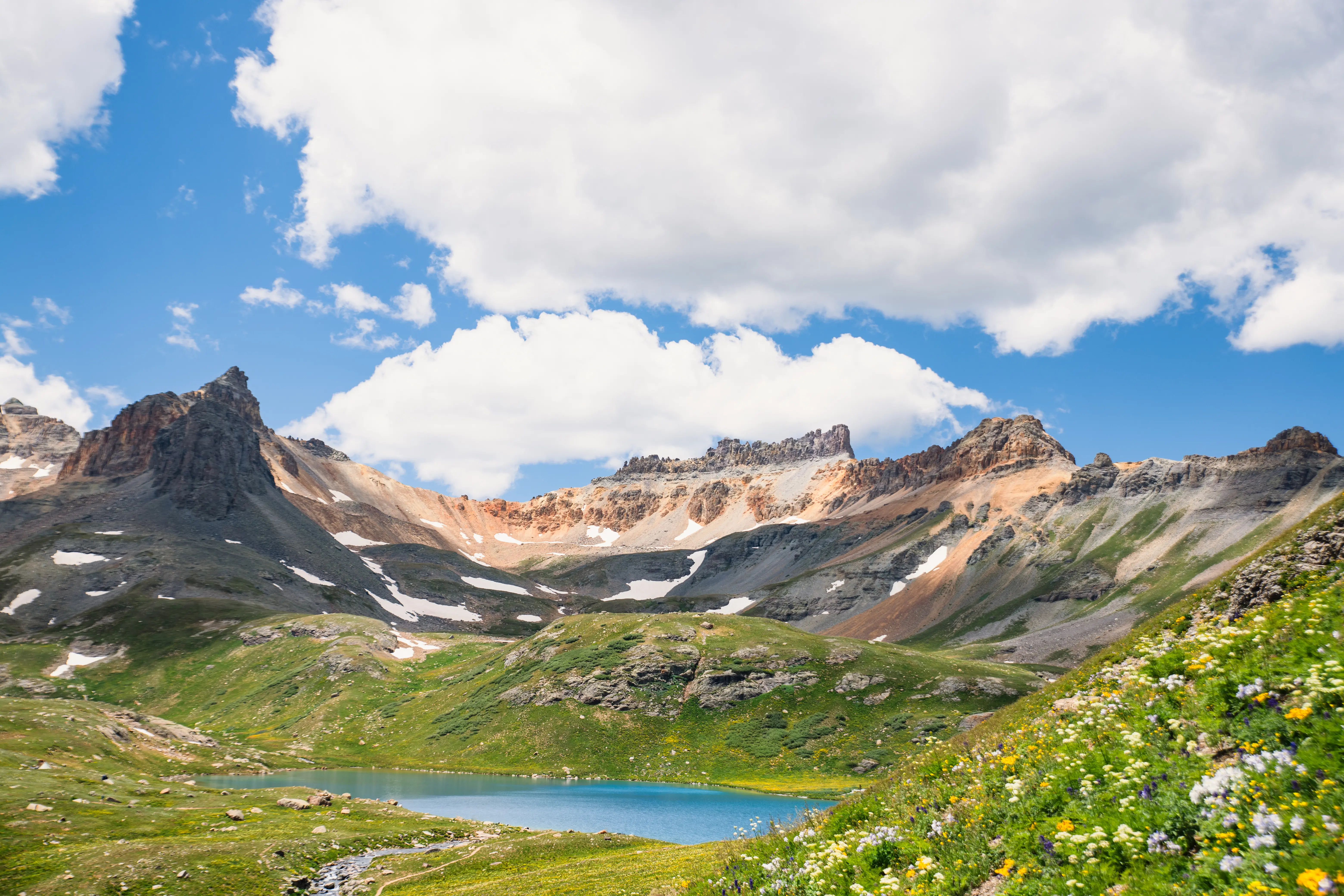 Streetside billboard with flyposters of the Batch.Works brand and illustrations