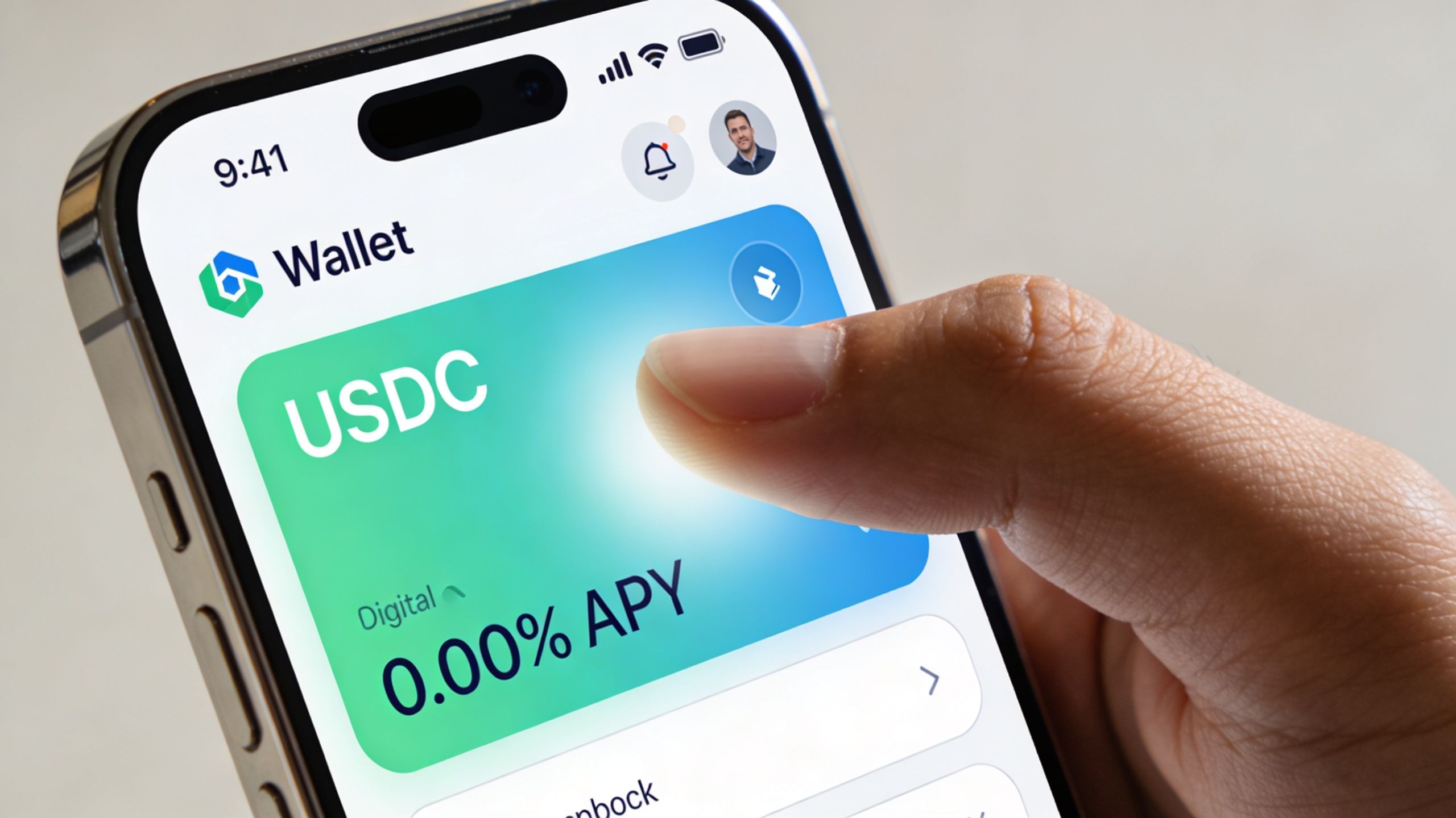 A hand holds a smartphone displaying a crypto wallet interface with a USDC balance card.