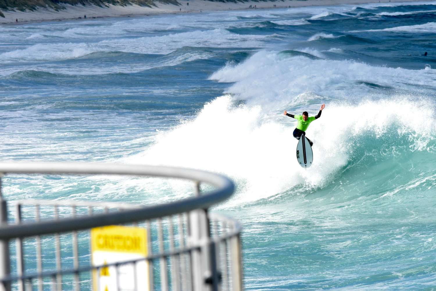 Action shot of a surfer riding a crisp blue wave — surfboard rental in Australia & Pacific