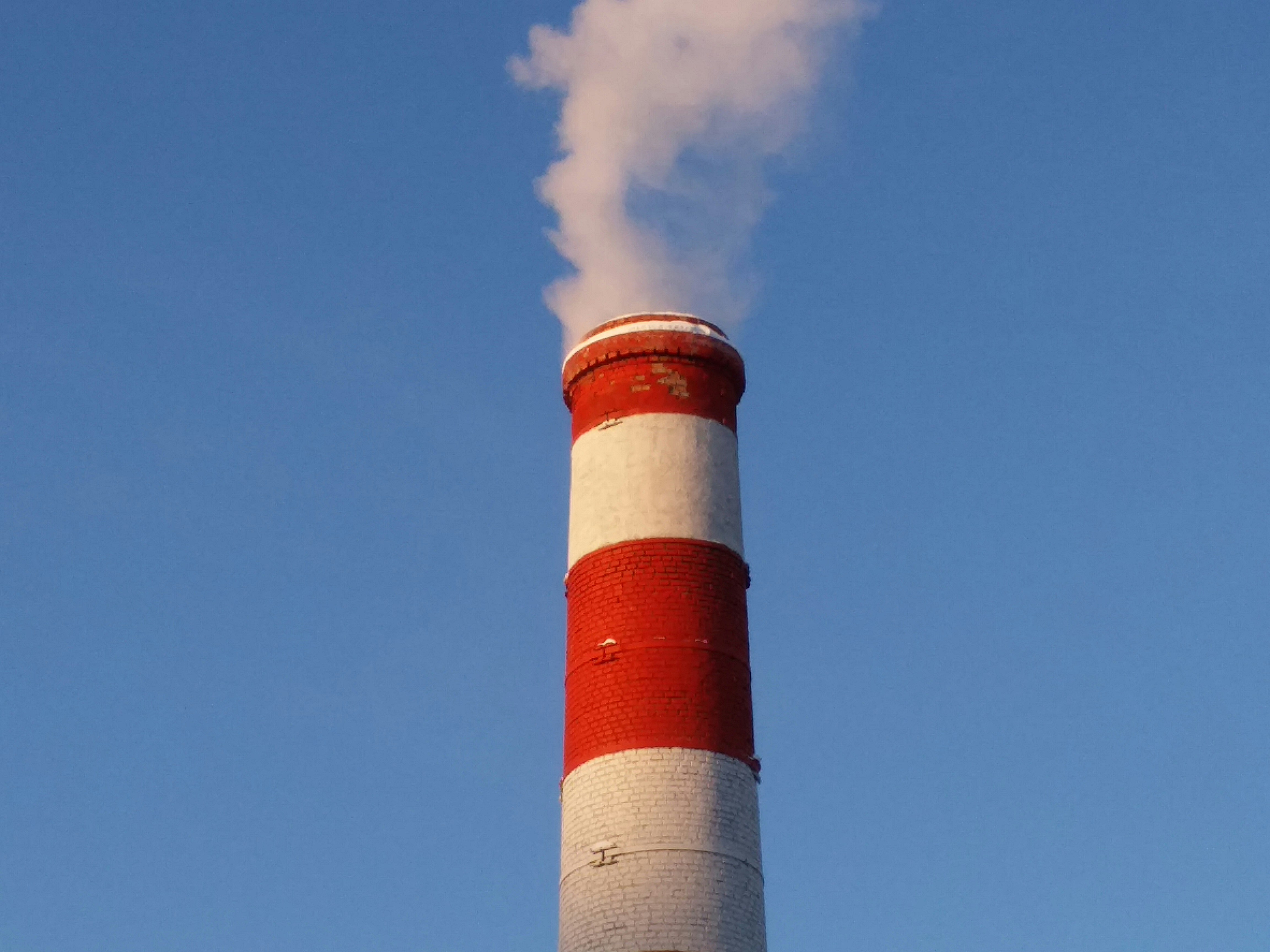 white and red concrete tower under blue sky during daytime