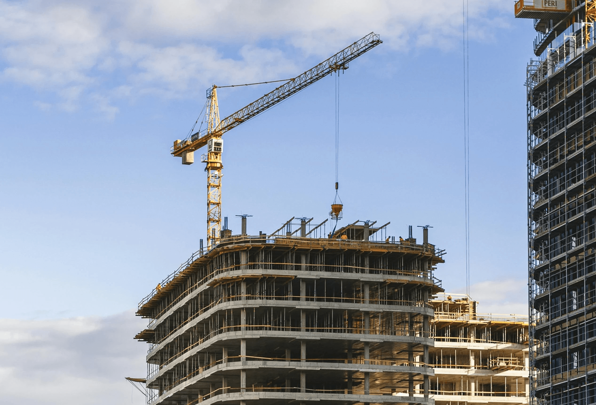 Commercial building construction with tower crane at active project site in Bangalore