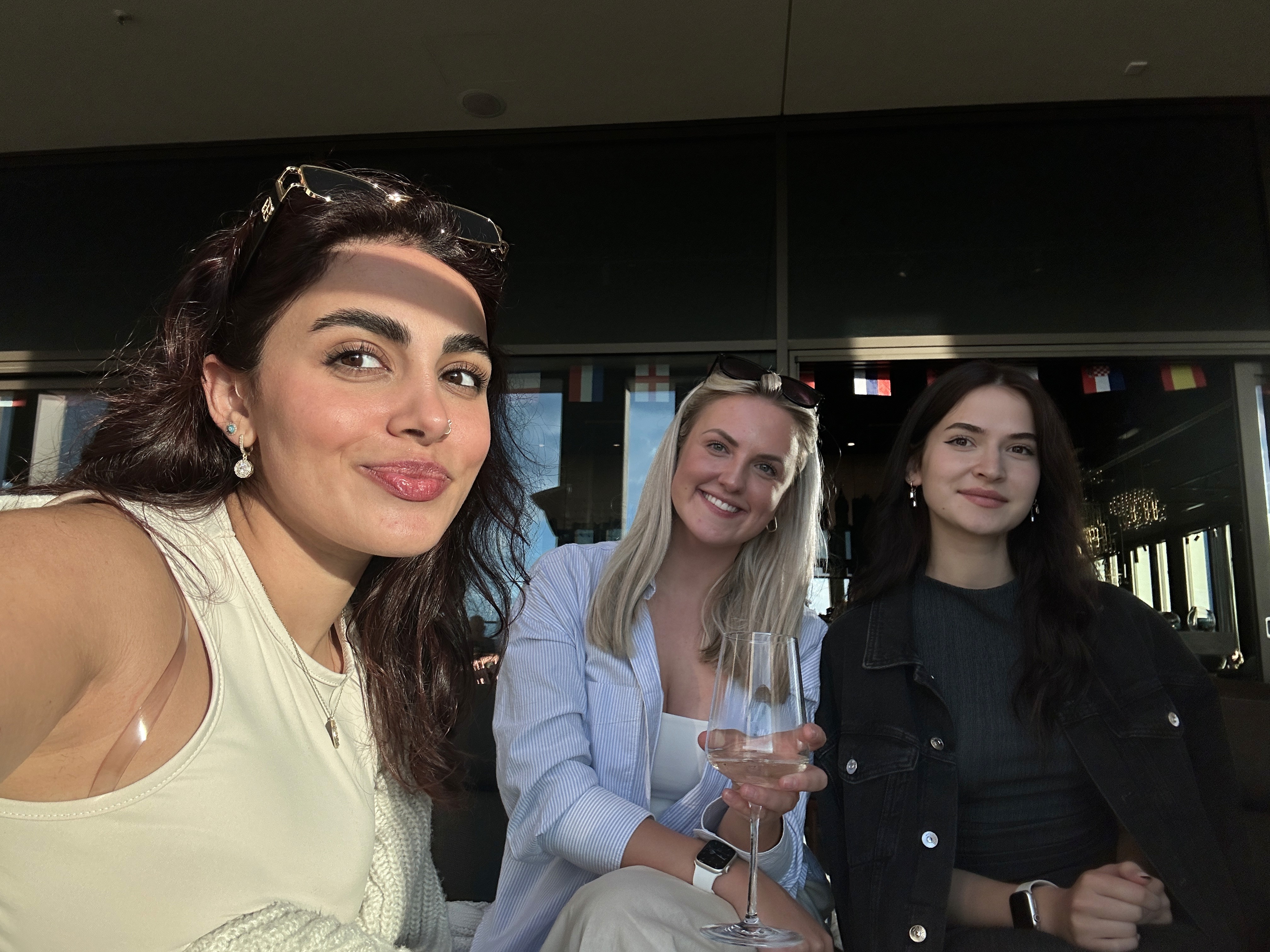 Group of friends smiling on a lively city street at night