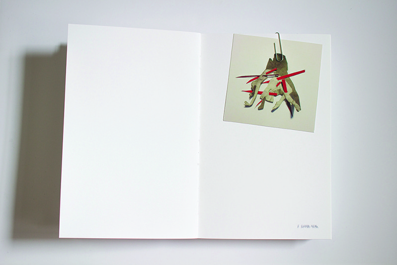 an illustration paper clipped on a book