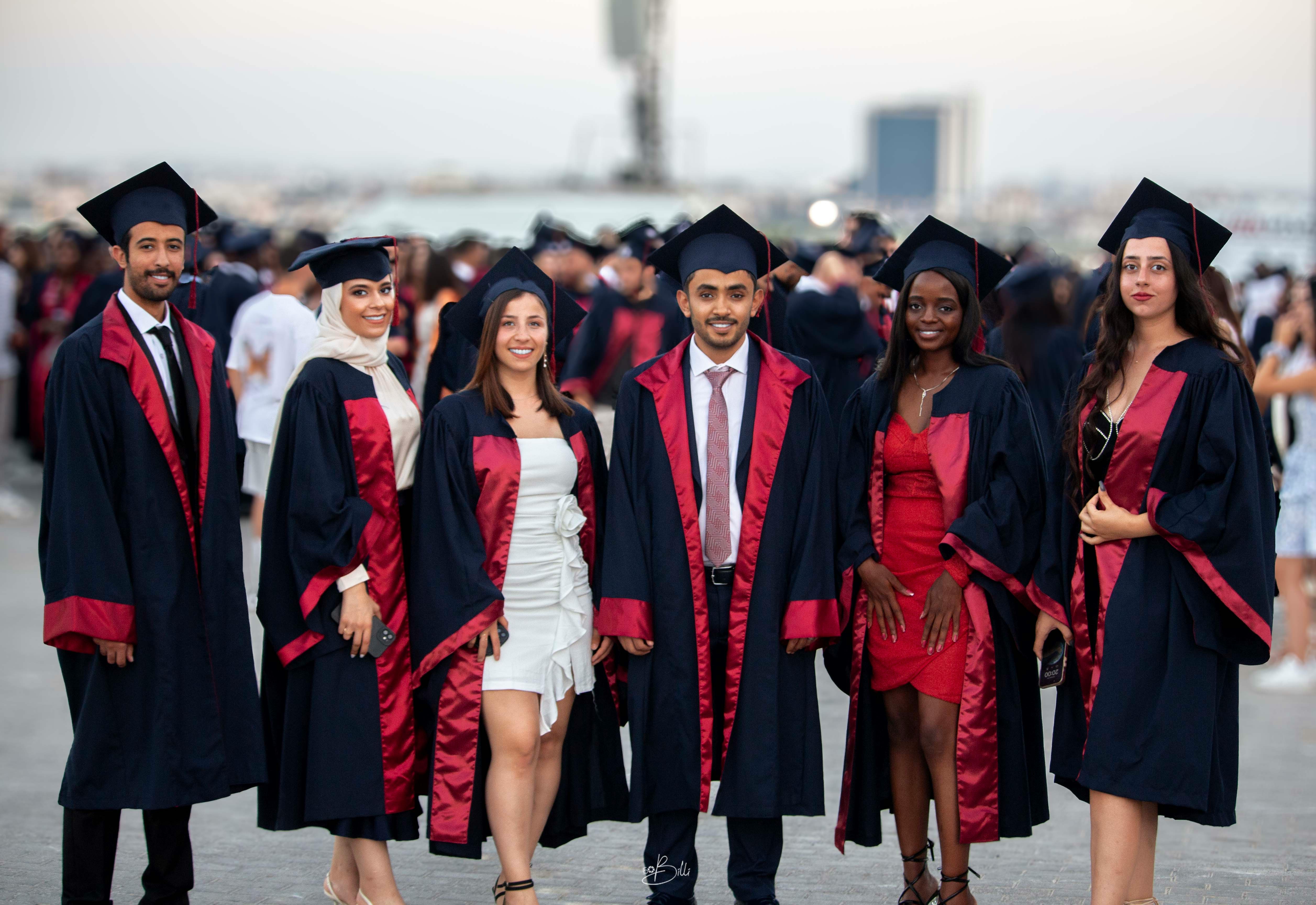 Diverse group of graduates in caps and gowns celebrating academic achievement, representing the start of their financial journey.