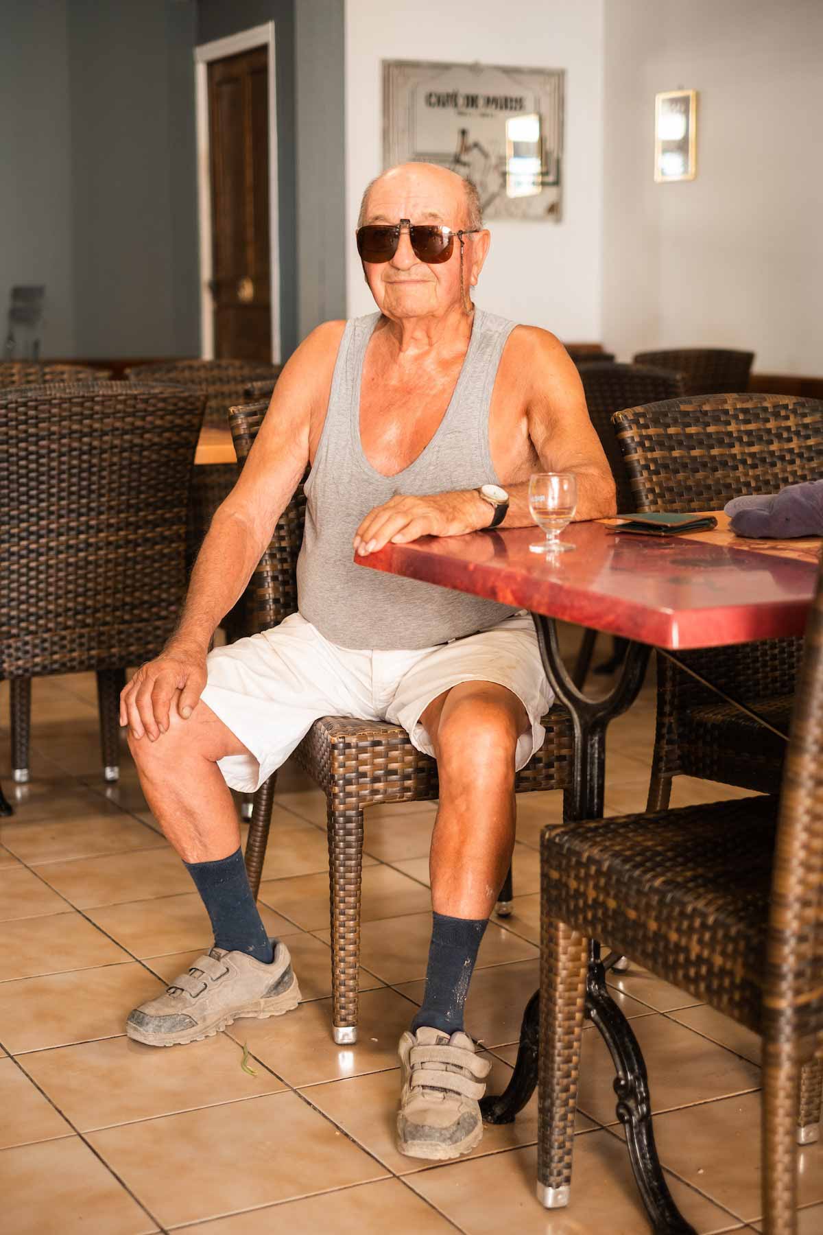 Oldman smiling in a bar