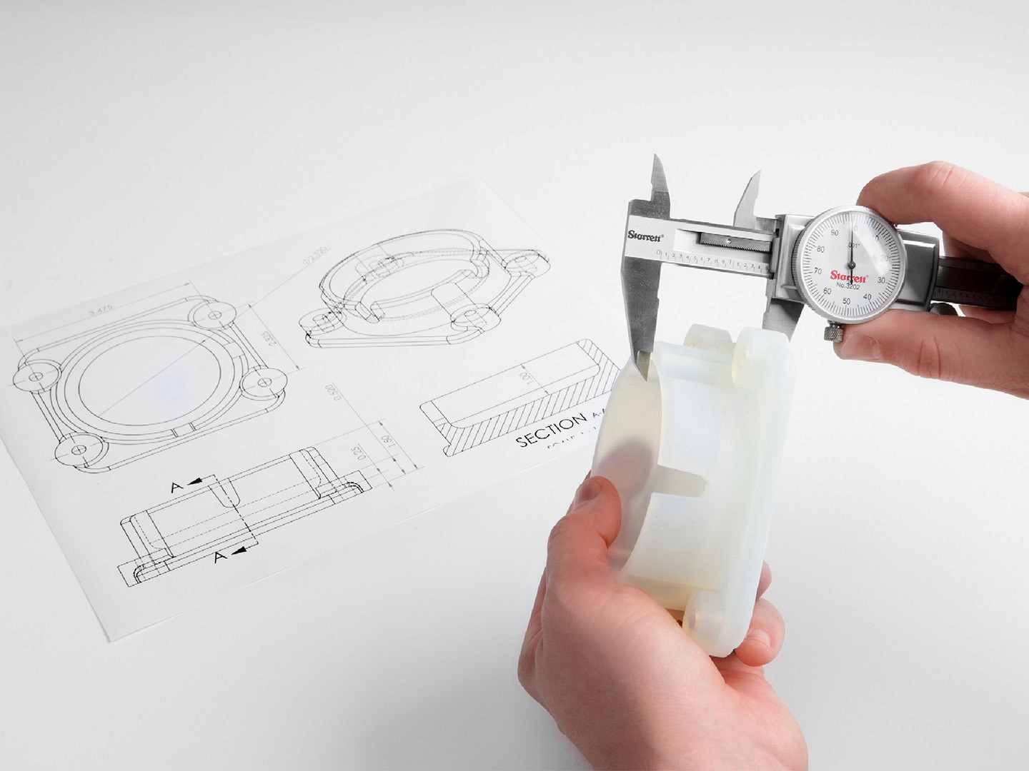 Calipers measuring component dimensions during manufacturing assistance process