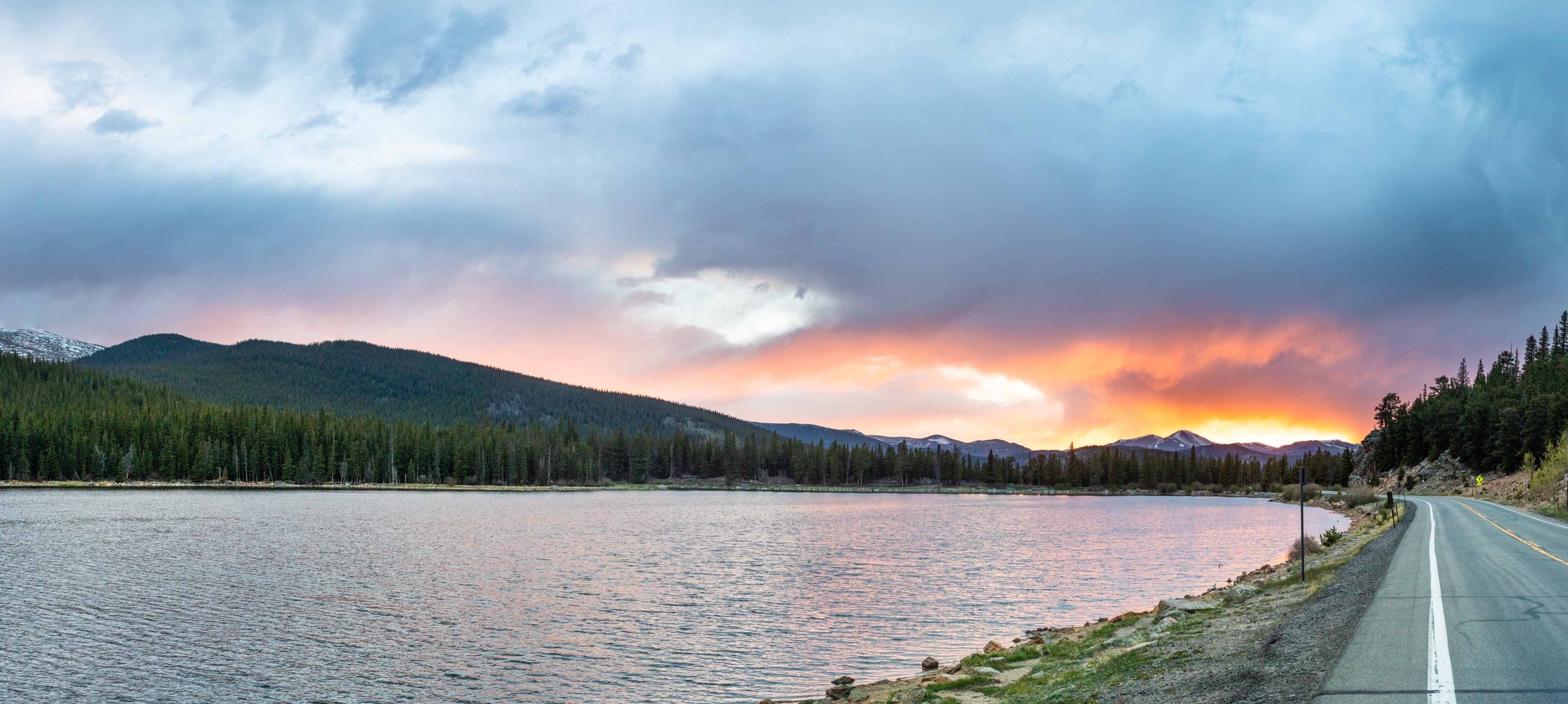Panoramic landscape photograph of mountains, water, desert, or coast by Lucas Jensen