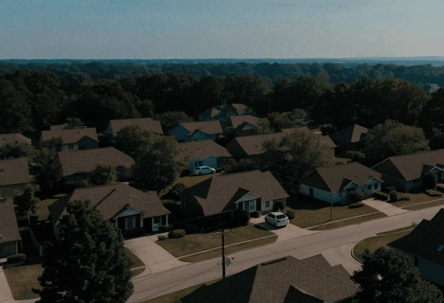 Aerial view of a residential subdivision of single-family homes among trees