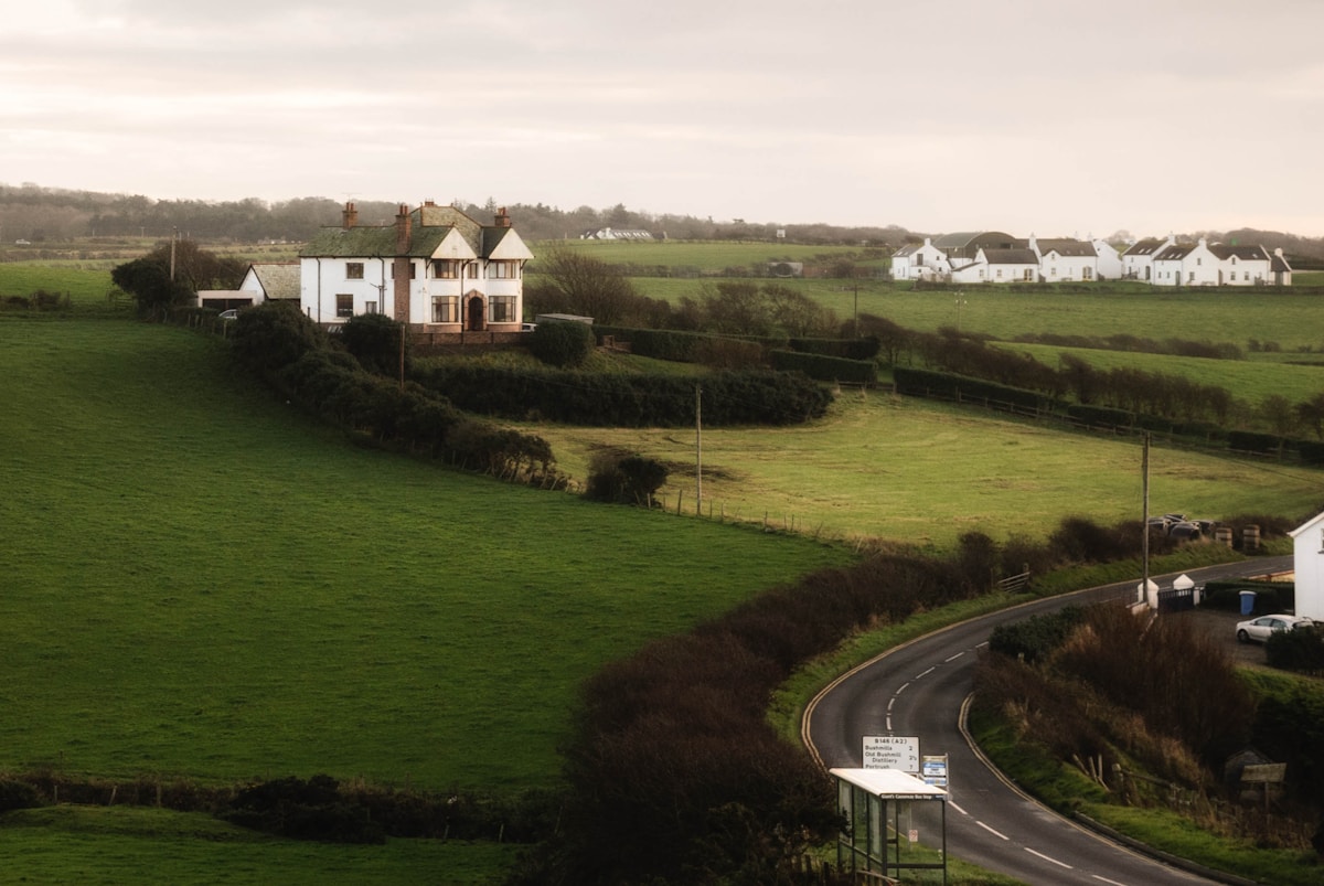 A rural home beside open green fields