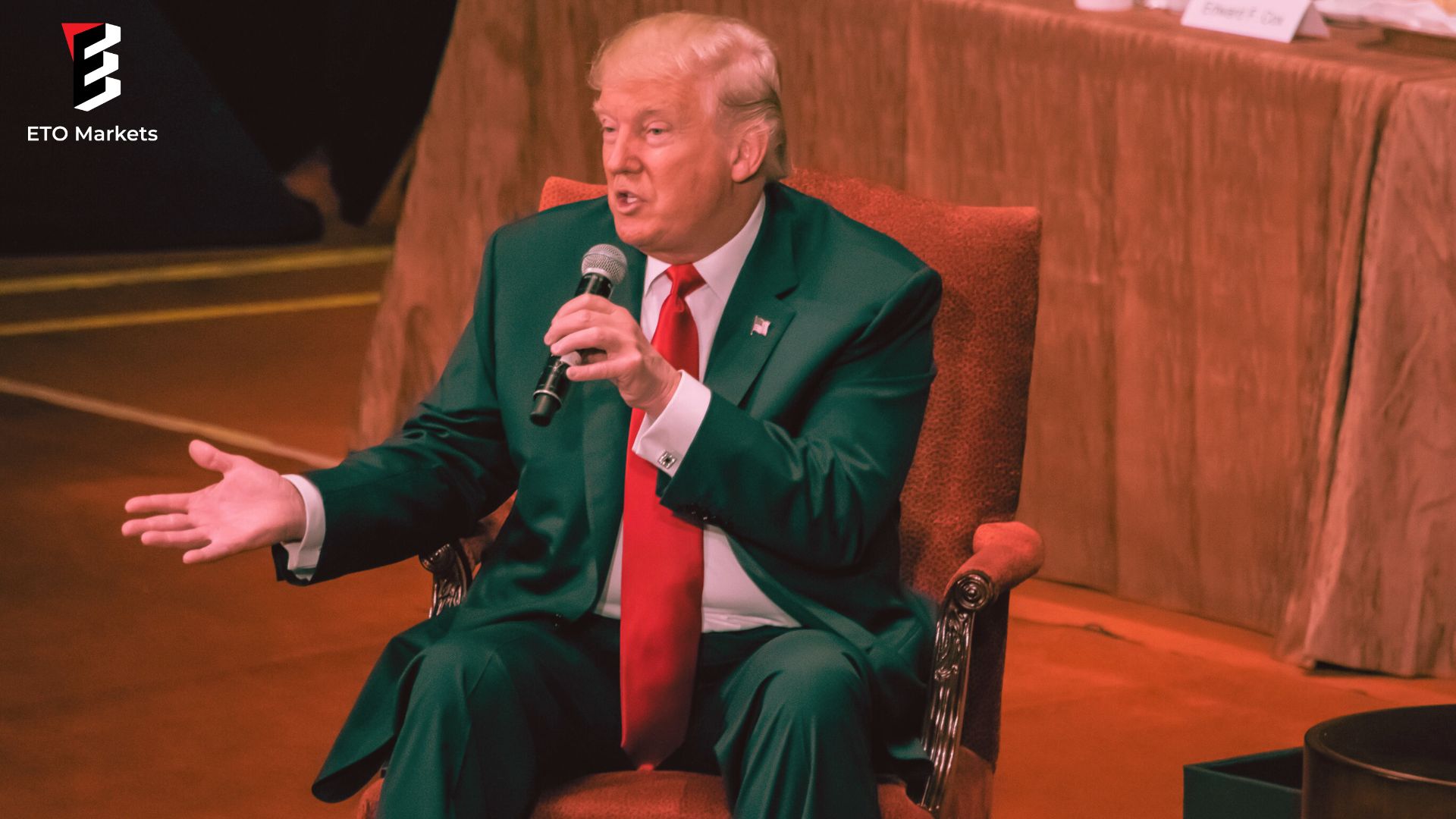 President Trump seated in a chair talking with a microphone