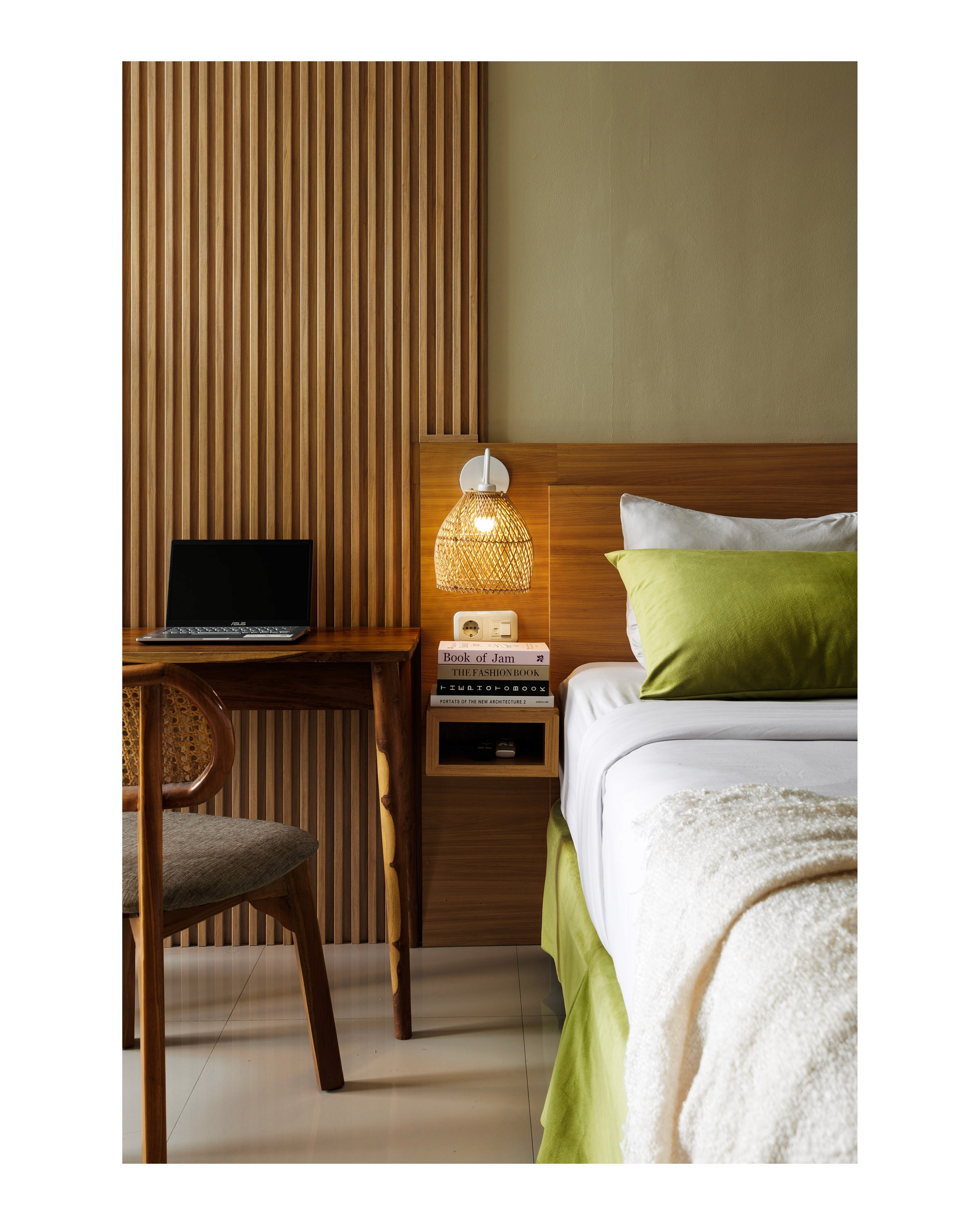 Wooden desk and rattan lamp detail atDeva Bali Apartment
