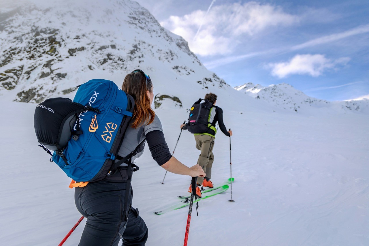 Ski touring ascent in the Mont Blanc area, with skiers climbing on skins in a snowy alpine backcountry environment