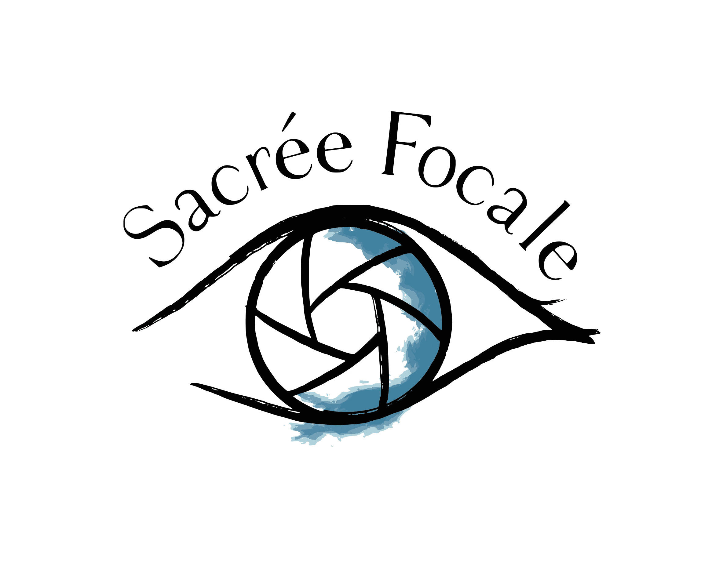 A large, striped hot air balloon flies low over rocky hills and unusual rock formations under a clear blue sky. A second balloon is visible in the distance.