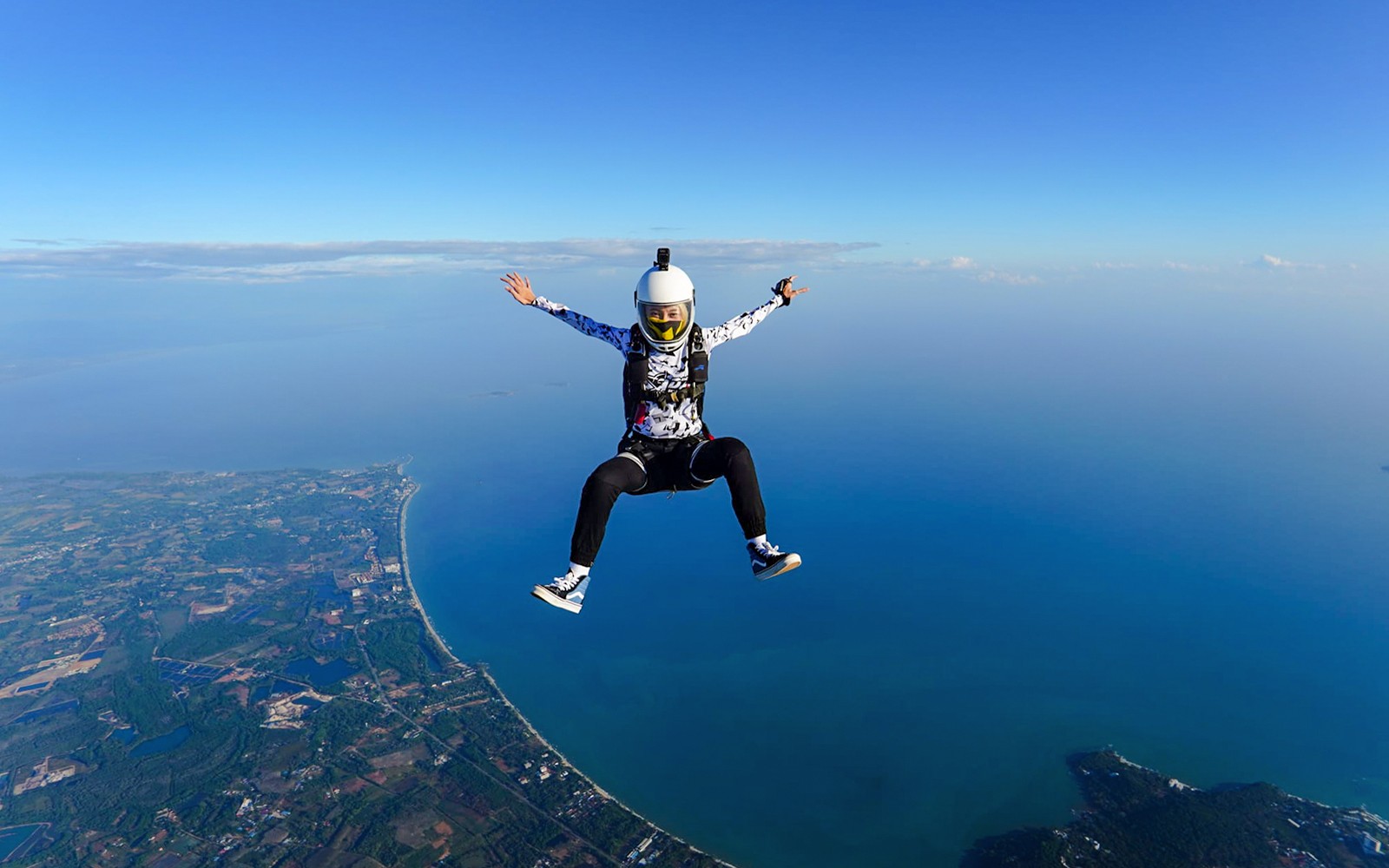 Skydiver over Pattaya coastline during Ocean View Tandem Skydive at 13,000 ft.