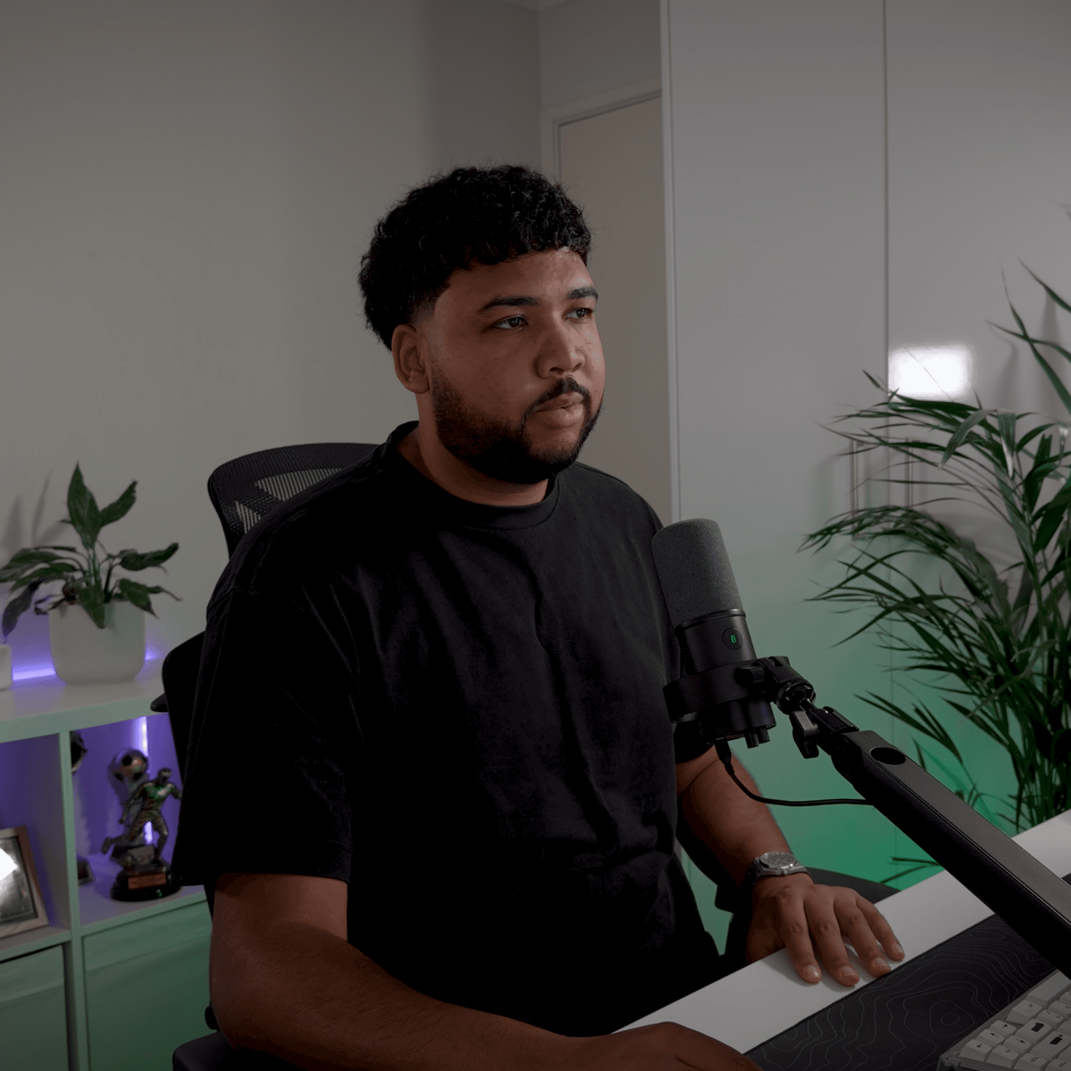 Profile portrait of a man in a white shirt against a light background