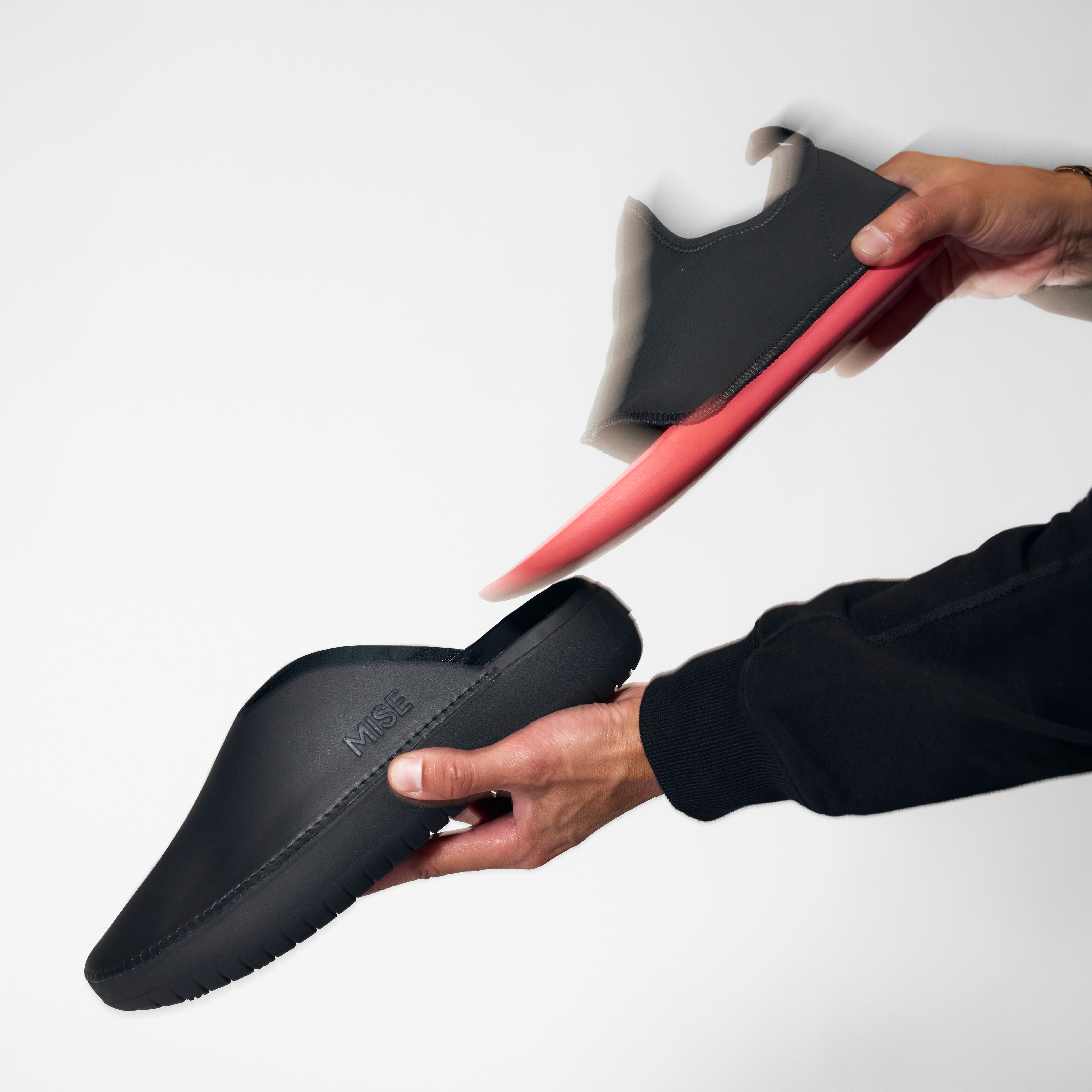 The Relaxed 2 MISE kitchen shoe insole in black being inserted into shell
