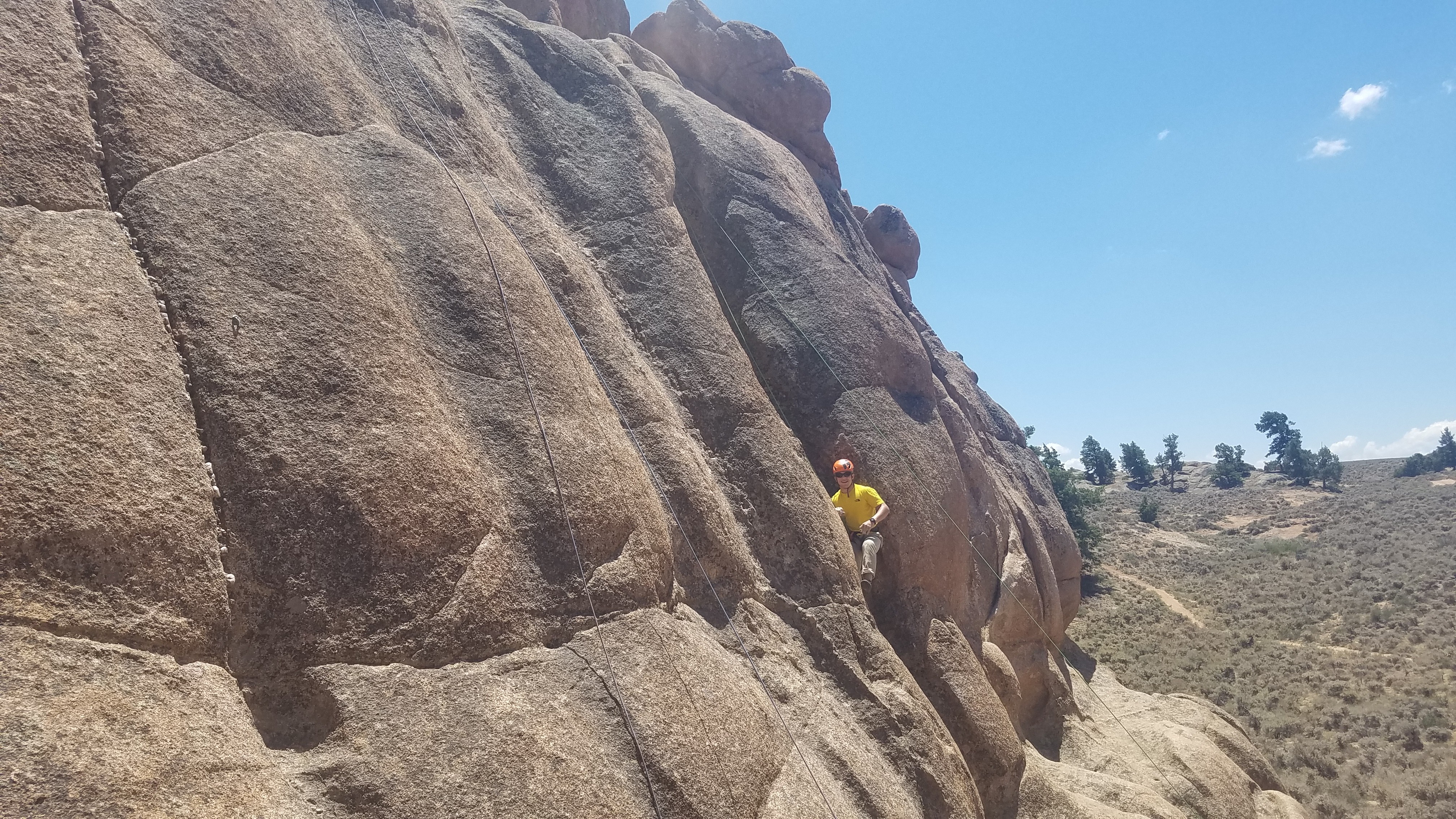 Climber smiles while in the middle of slab in hartman rocks
