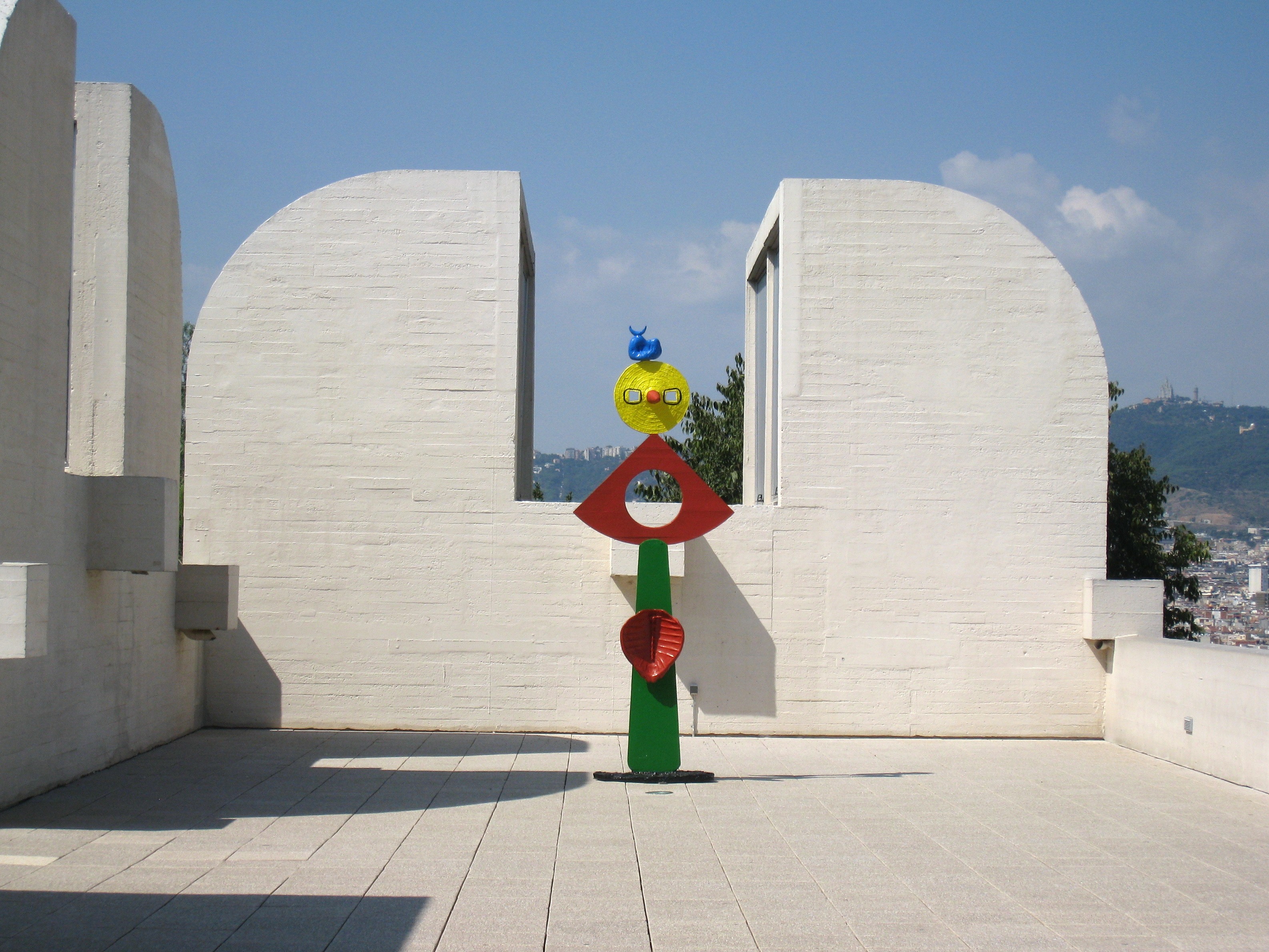 A colorful abstract outdoor sculpture, tall with a ball at the top, at the Fundacio Joan Miro in Barcelona.