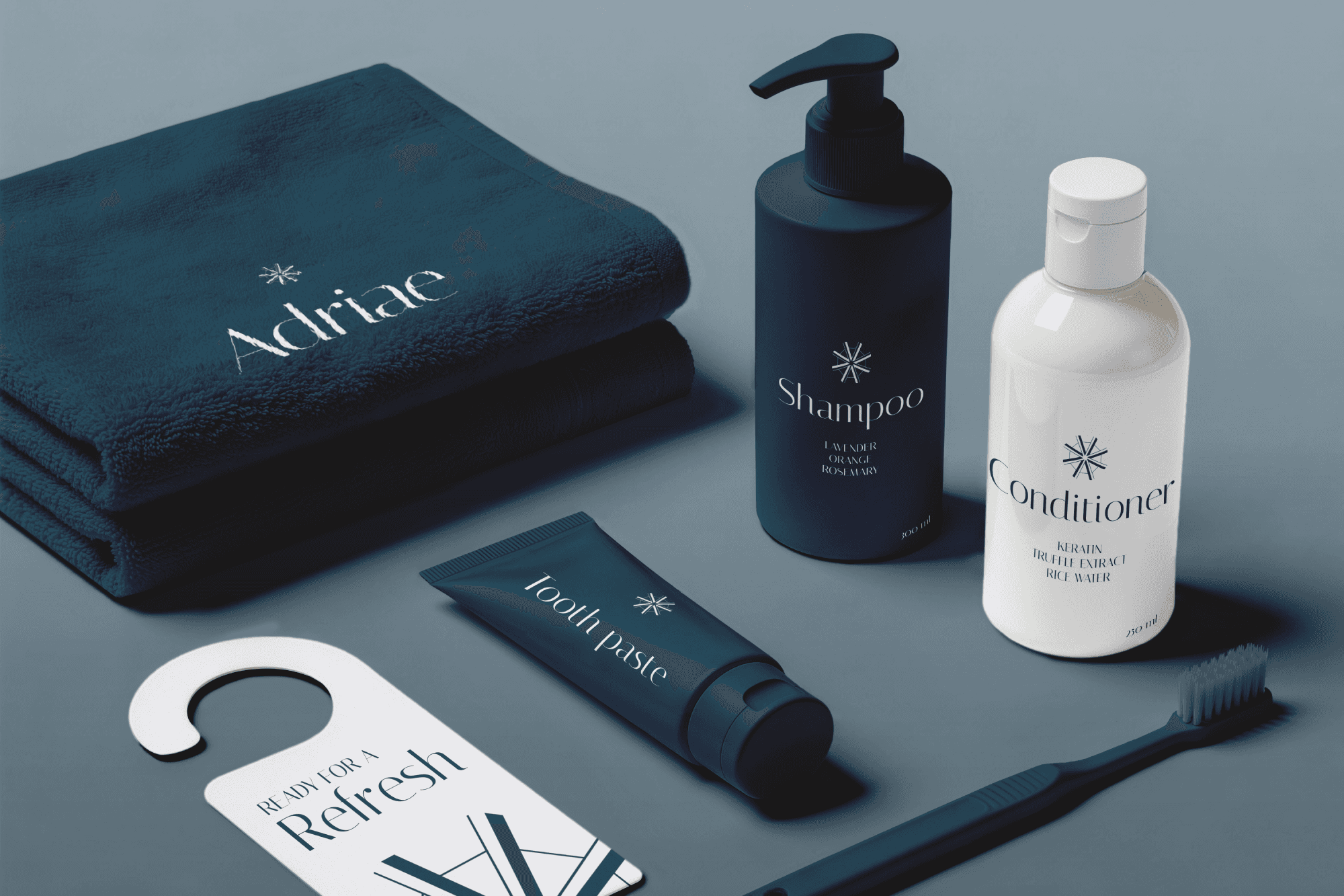 A luxury hospitality guest amenities mockup by Studio Liminal featuring a branded towel, toiletries, bathroom essentials, and a custom door hanger for Adriae villas.