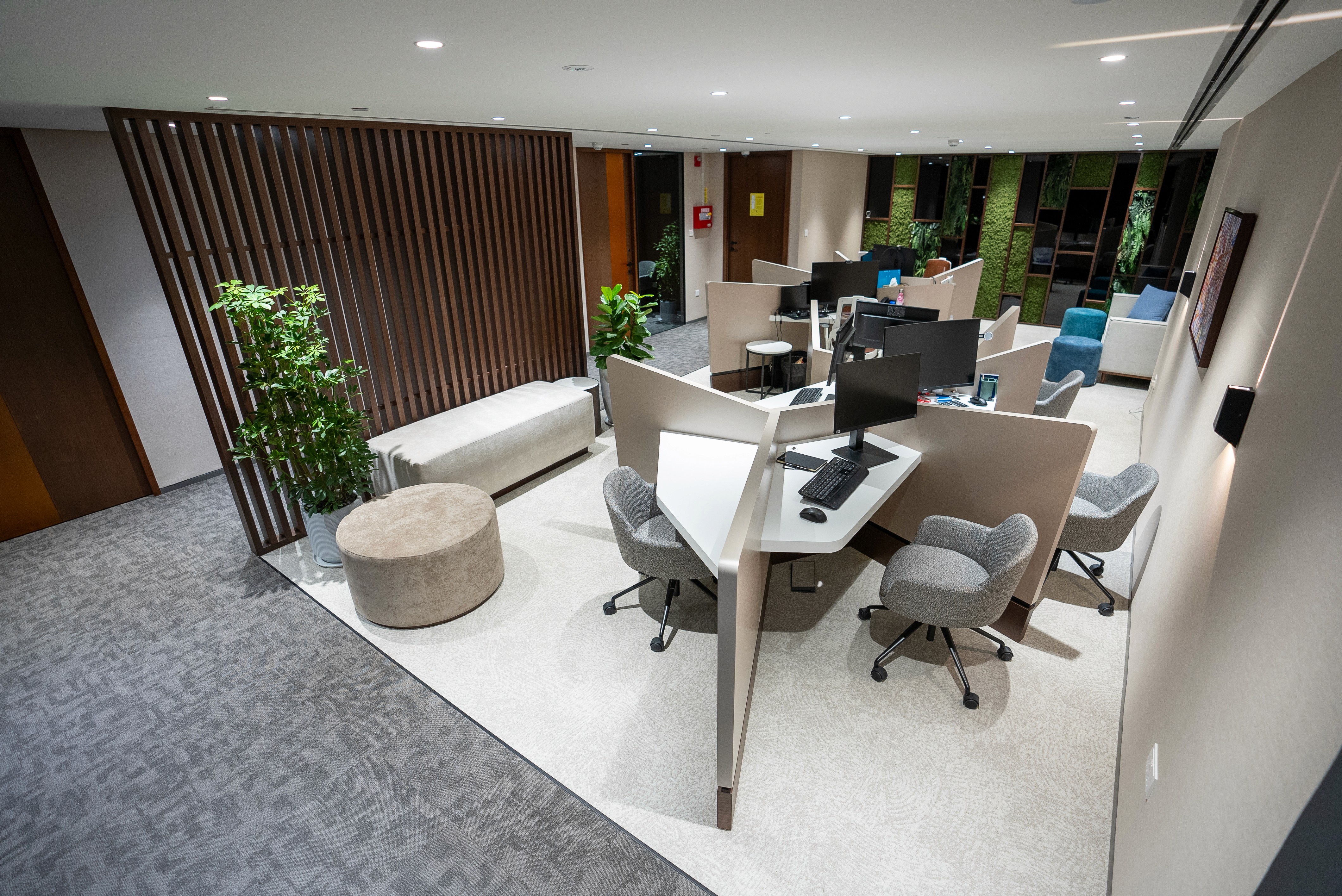 Coworking space at Nation Towers Mall featuring sleek wood interiors and modern ergonomic seating.