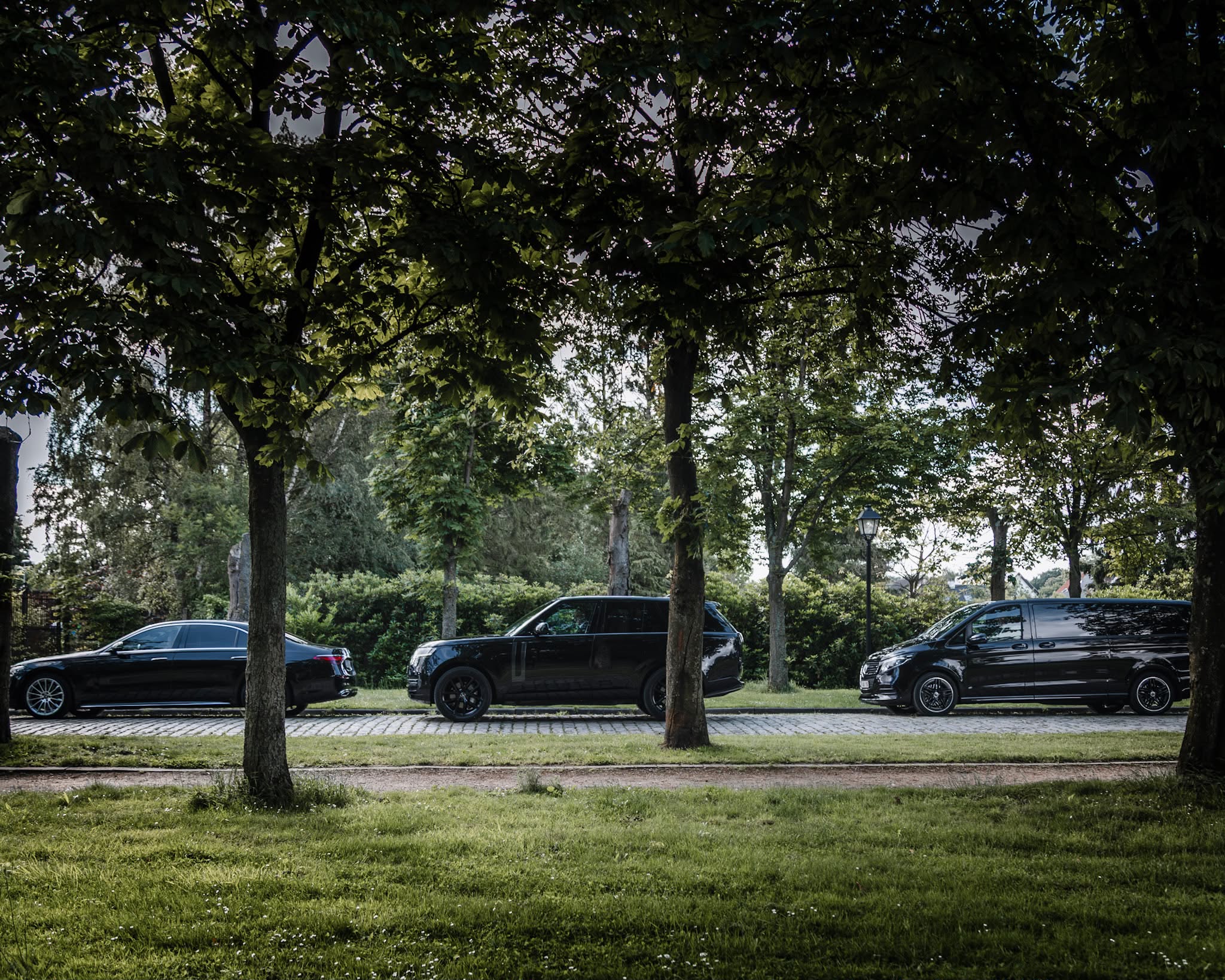Vooraanzicht van twee schuin geparkeerde Mercedes-Benz V-Klasse busjes naast elkaar