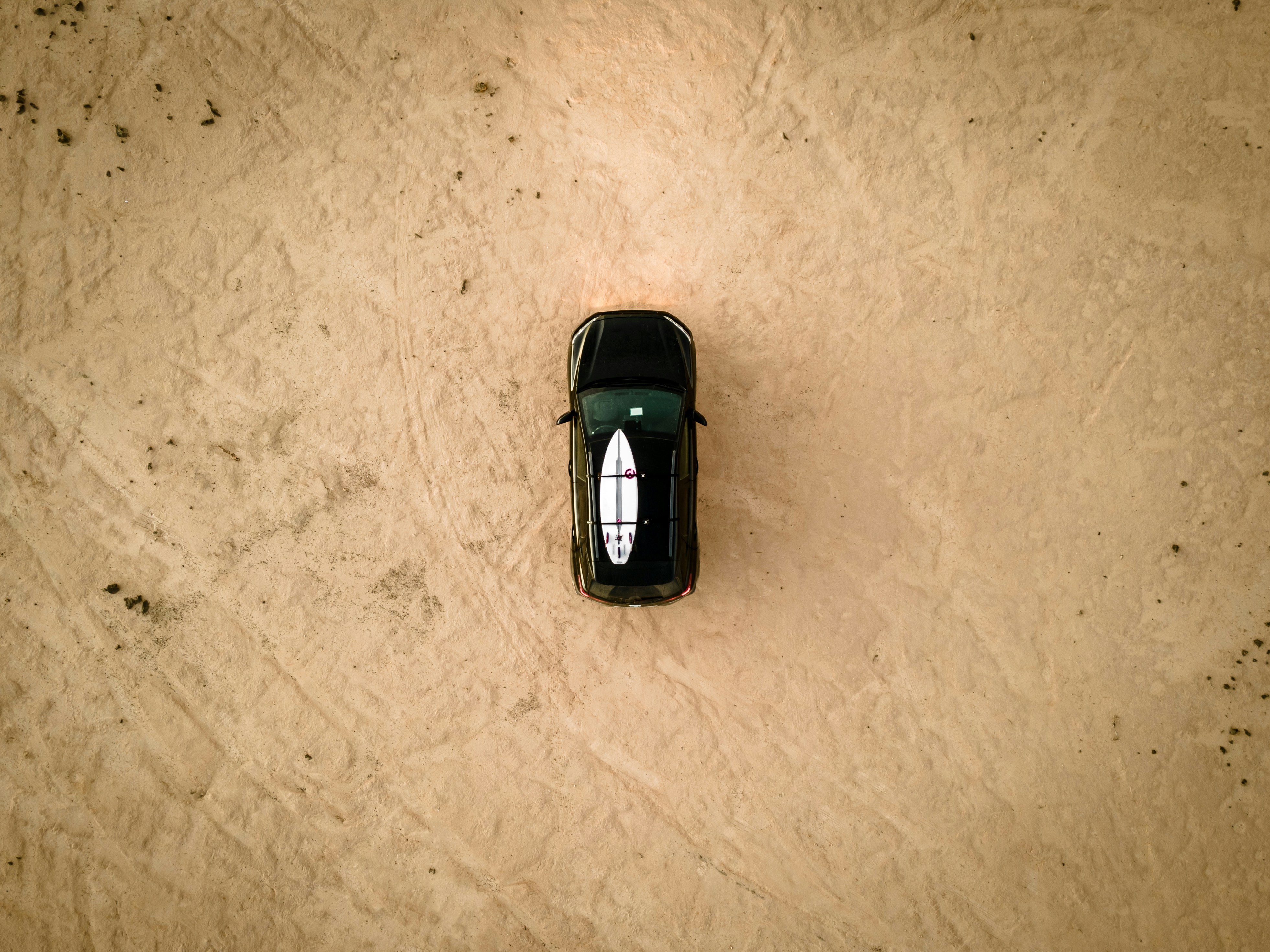 Birdview of a car on the beach.