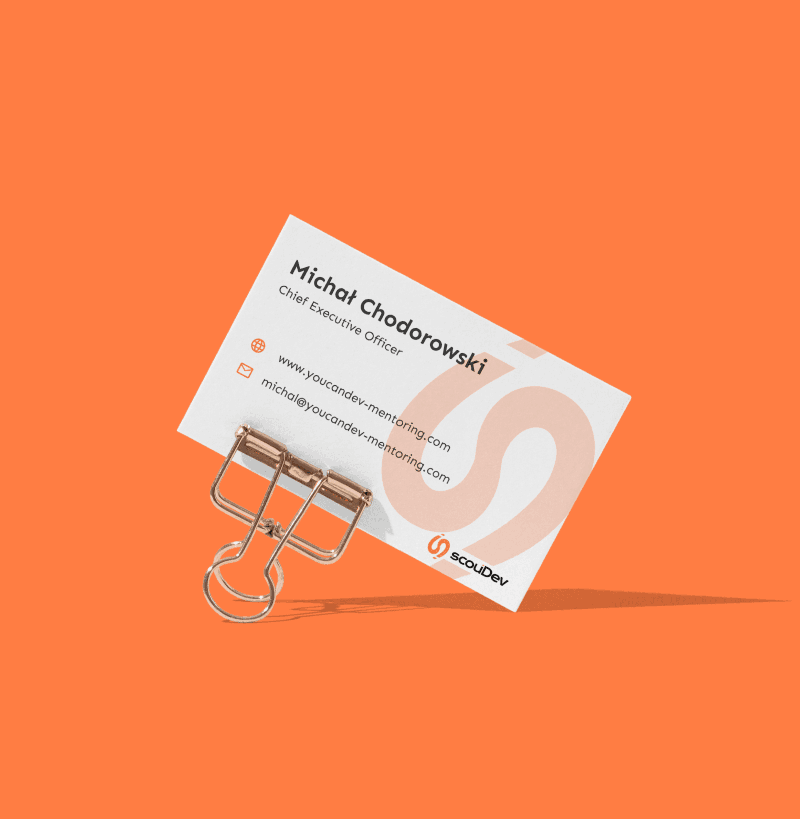 Scoudev logo on a business card mockup.