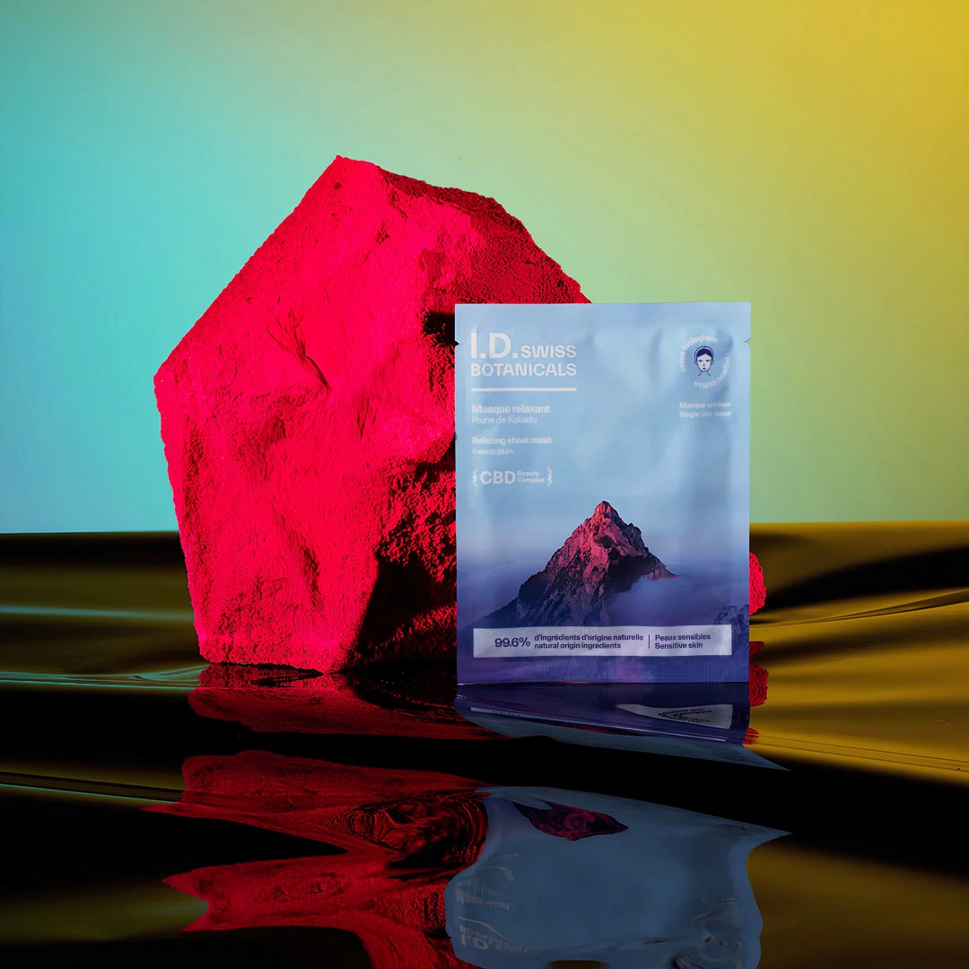 I.D. Swiss Botanicals CBD sheet mask showcased in a vibrant campaign composition highlighting premium skincare packaging