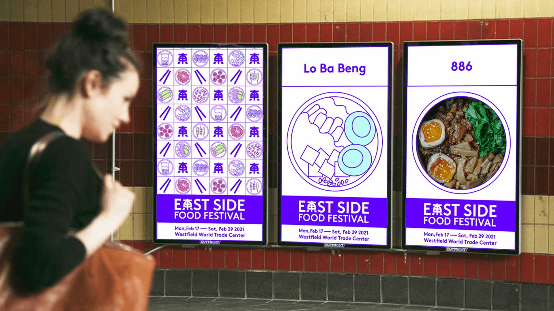 A woman with dark hair pulled back in a bun walks past three vertical digital displays mounted on a brick wall. The displays advertise the "East Side Food Festival," with dates from Monday, February 17 to Saturday, February 29, 2021, at the Westfield World Trade Center. Each display features a purple banner with white text and icons. The rightmost display shows a bowl of food with meat, vegetables, and sauce. The leftmost display shows a grid of colorful icons. The middle display has a circular design with light blue circles. The rightmost display shows the number 886.