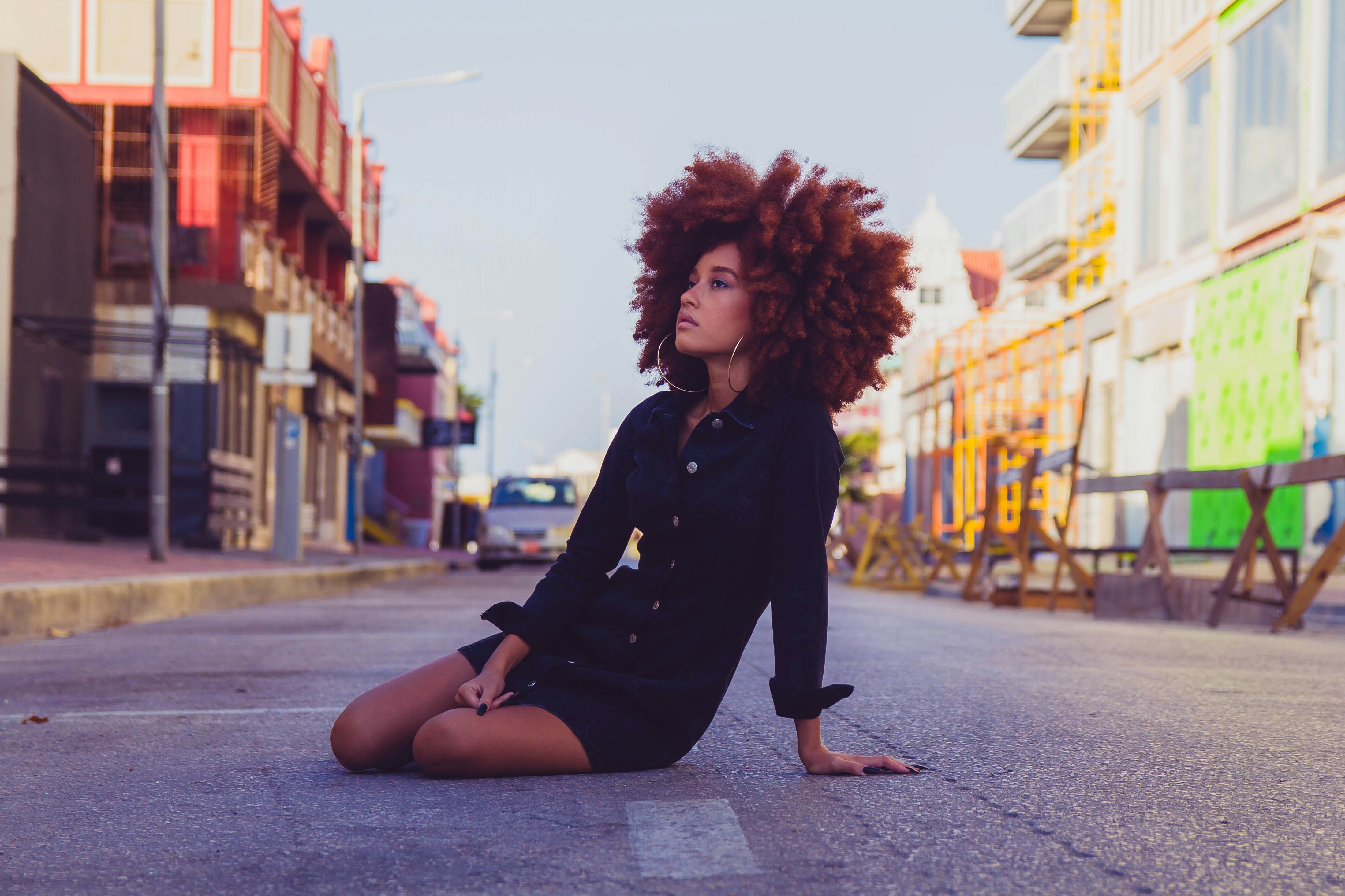 woman sitting on roadside - Colors For Summer Skin Tone