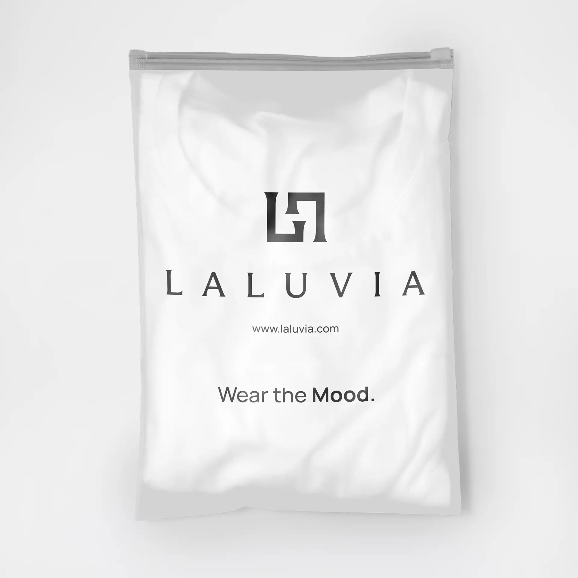 Branded transparent garment packaging for Laluvia featuring the monogram logo and the slogan "Wear the Mood".