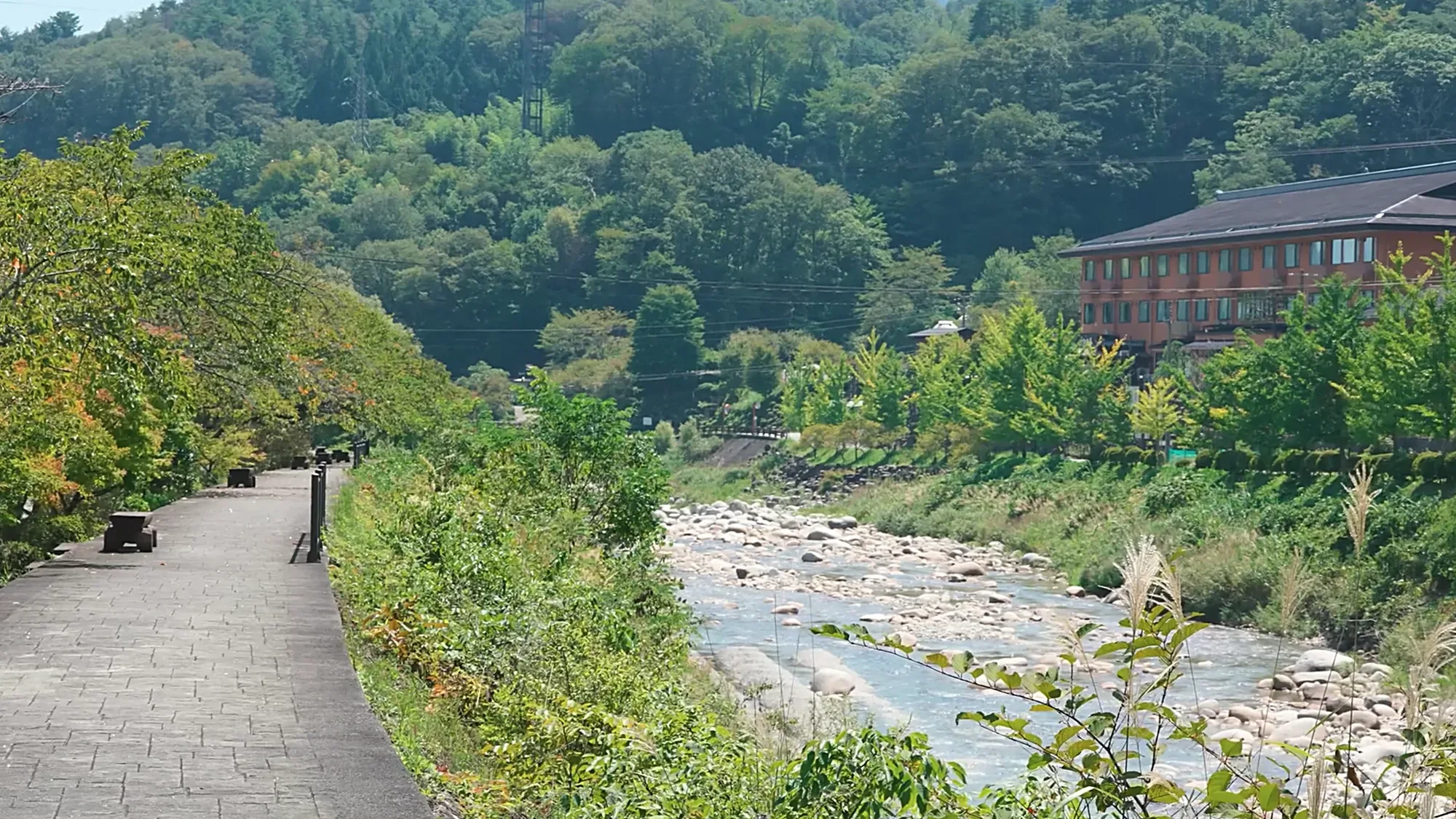 A riverside path beside an inn at Kurokawa Onsen in summer