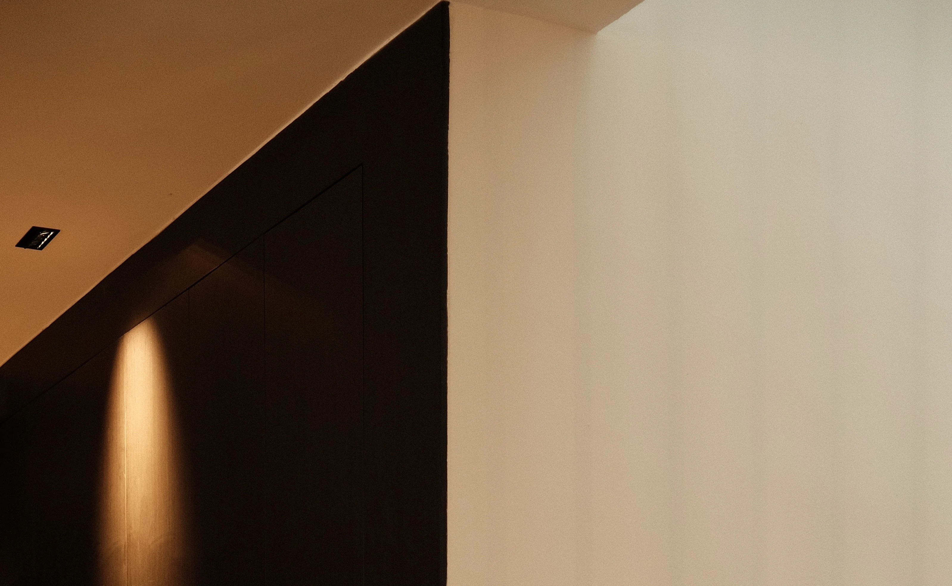 Minimalist hallway with concealed door and soft ambient lighting, contemporary interior by Persqft