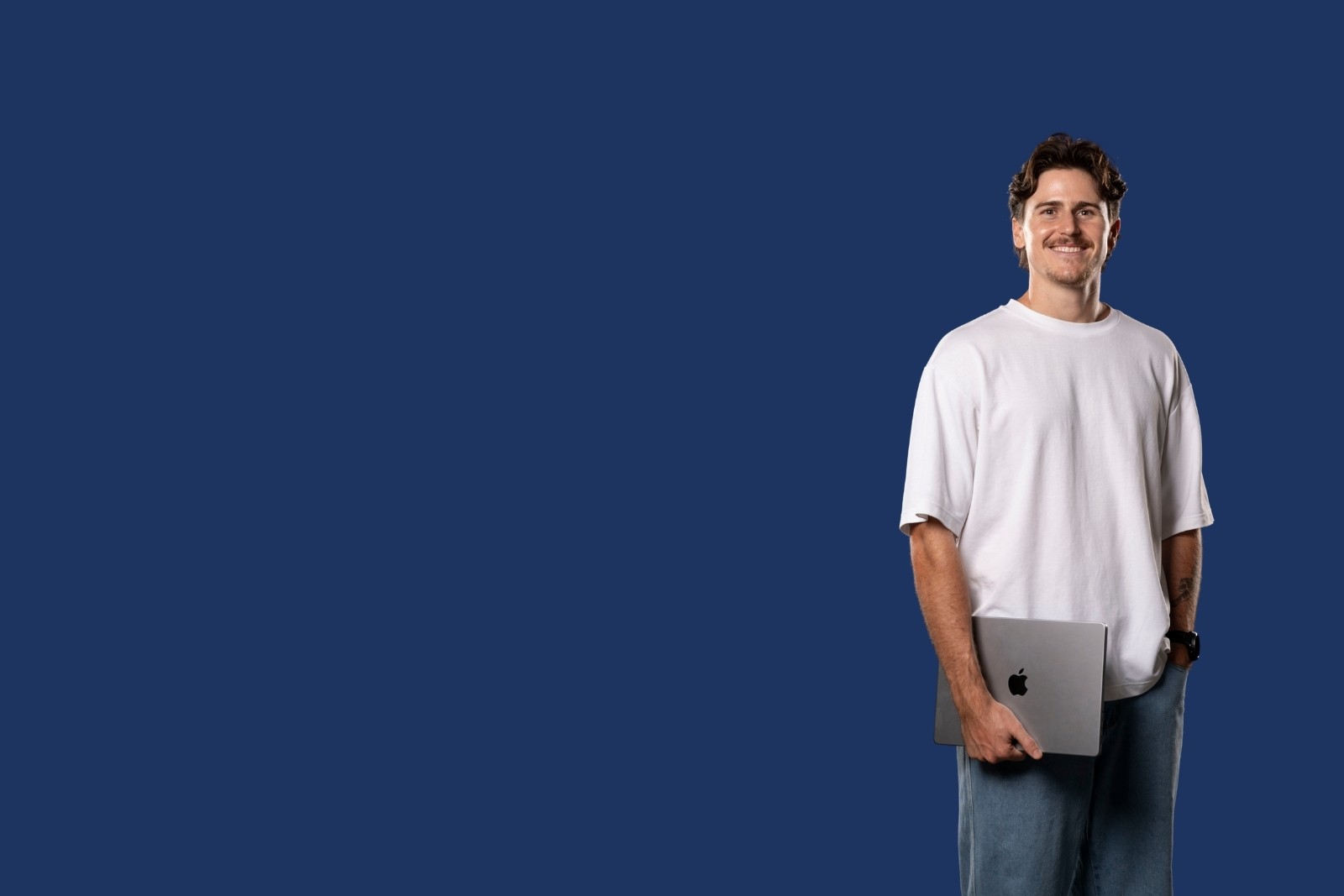 Bailey standing holding laptop