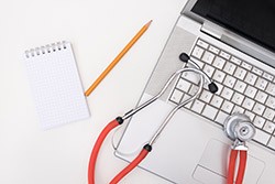 Stethoscope on laptop