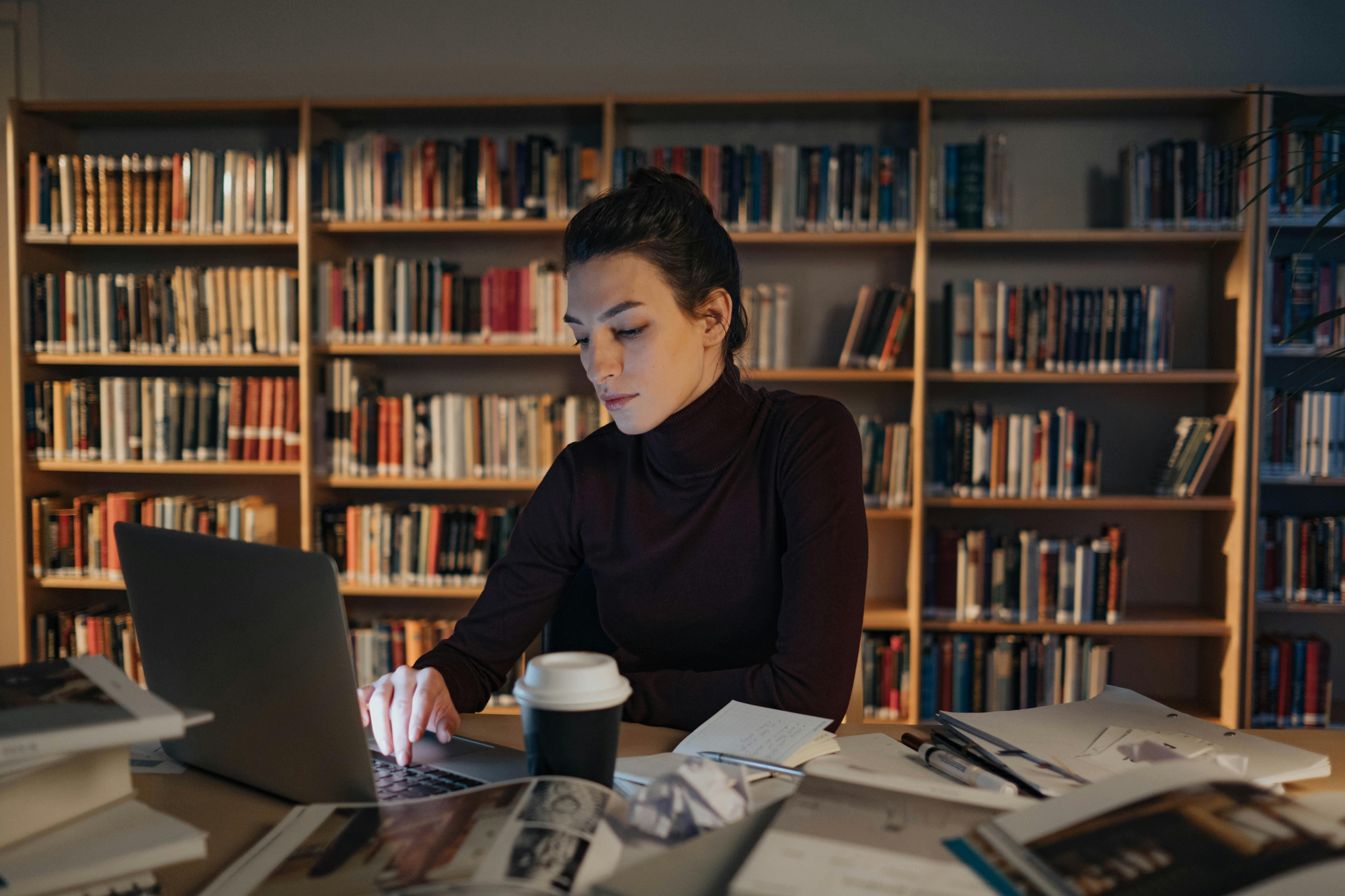 A Woman using a Laptop as she does reserach