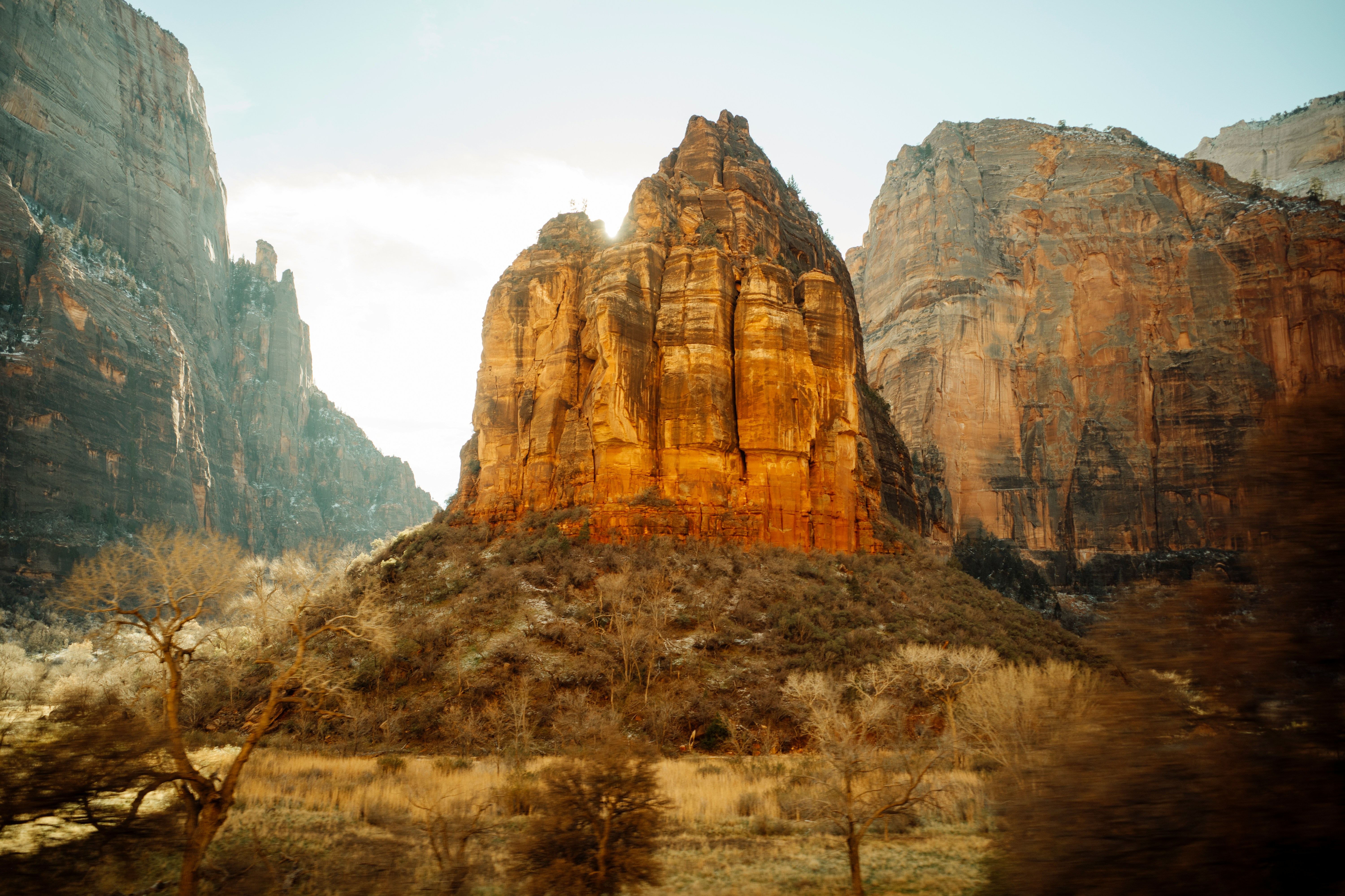 Towering sandstone cliffs bathed in warm sunlight