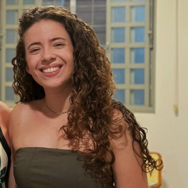 a woman in a blue top and black shorts
